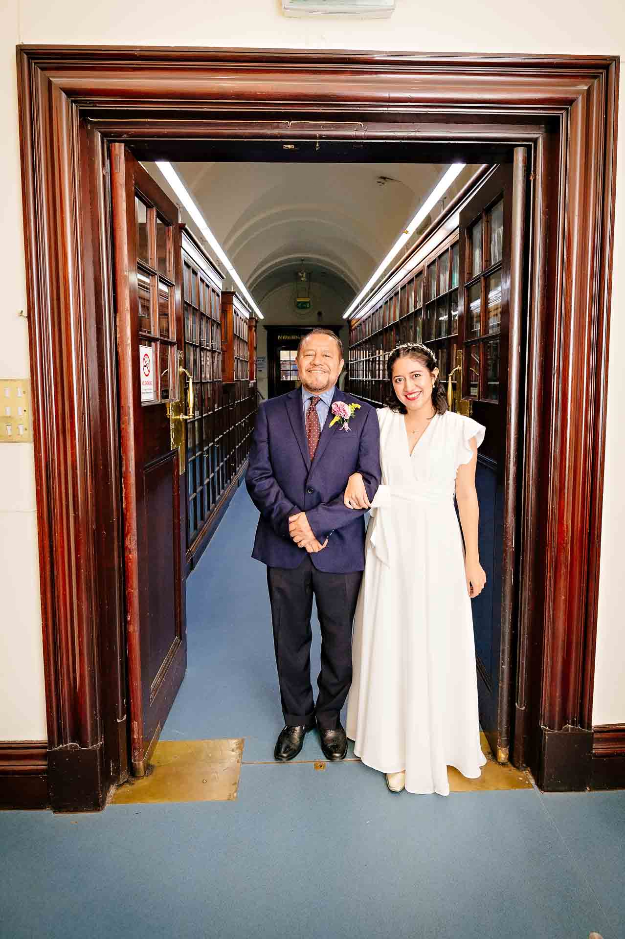 Bride with Father waiting in the Fine Art Collection Corridor at Fulham Library