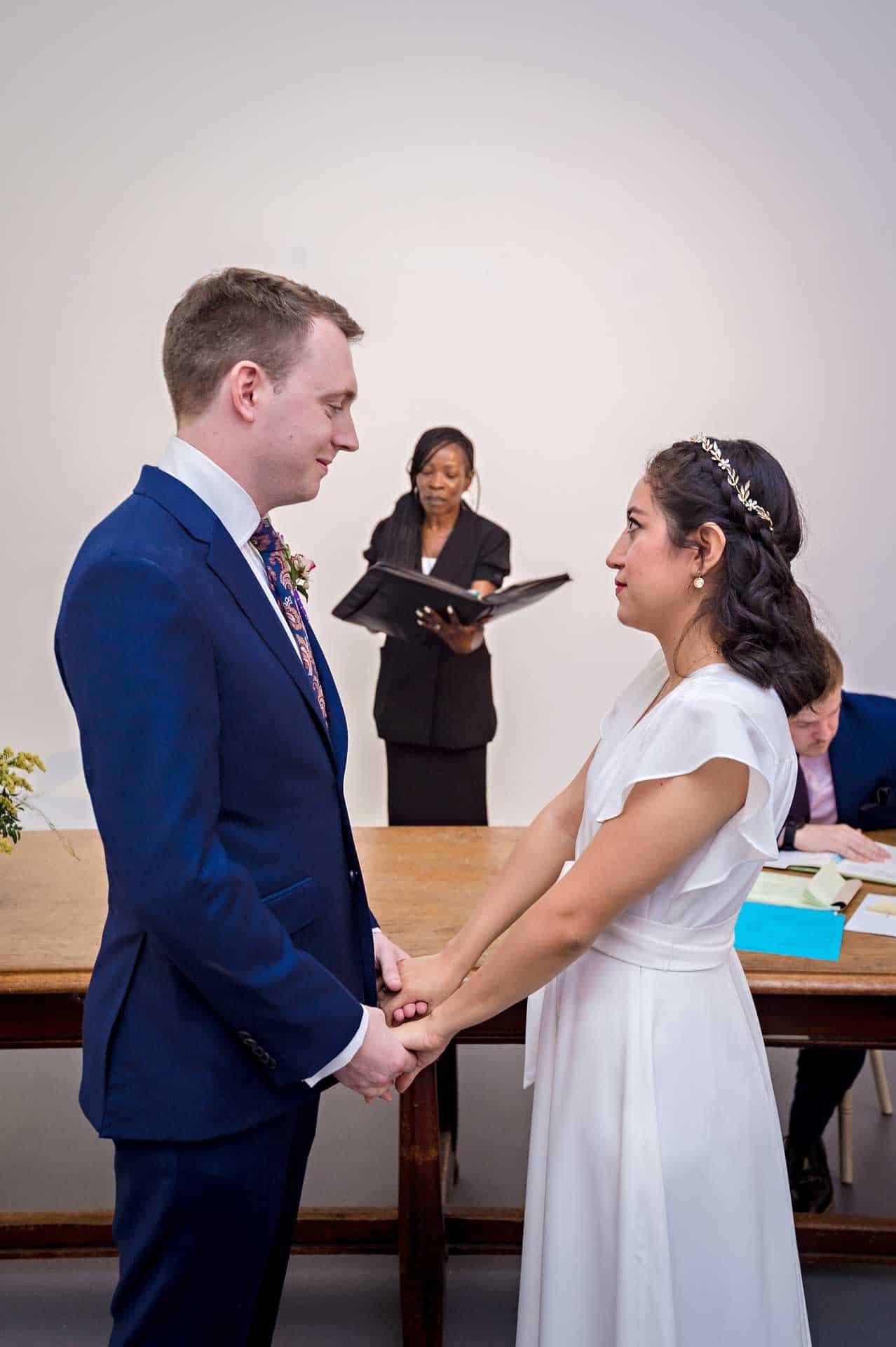 Wedding Couple Holding Hands During Ceremony