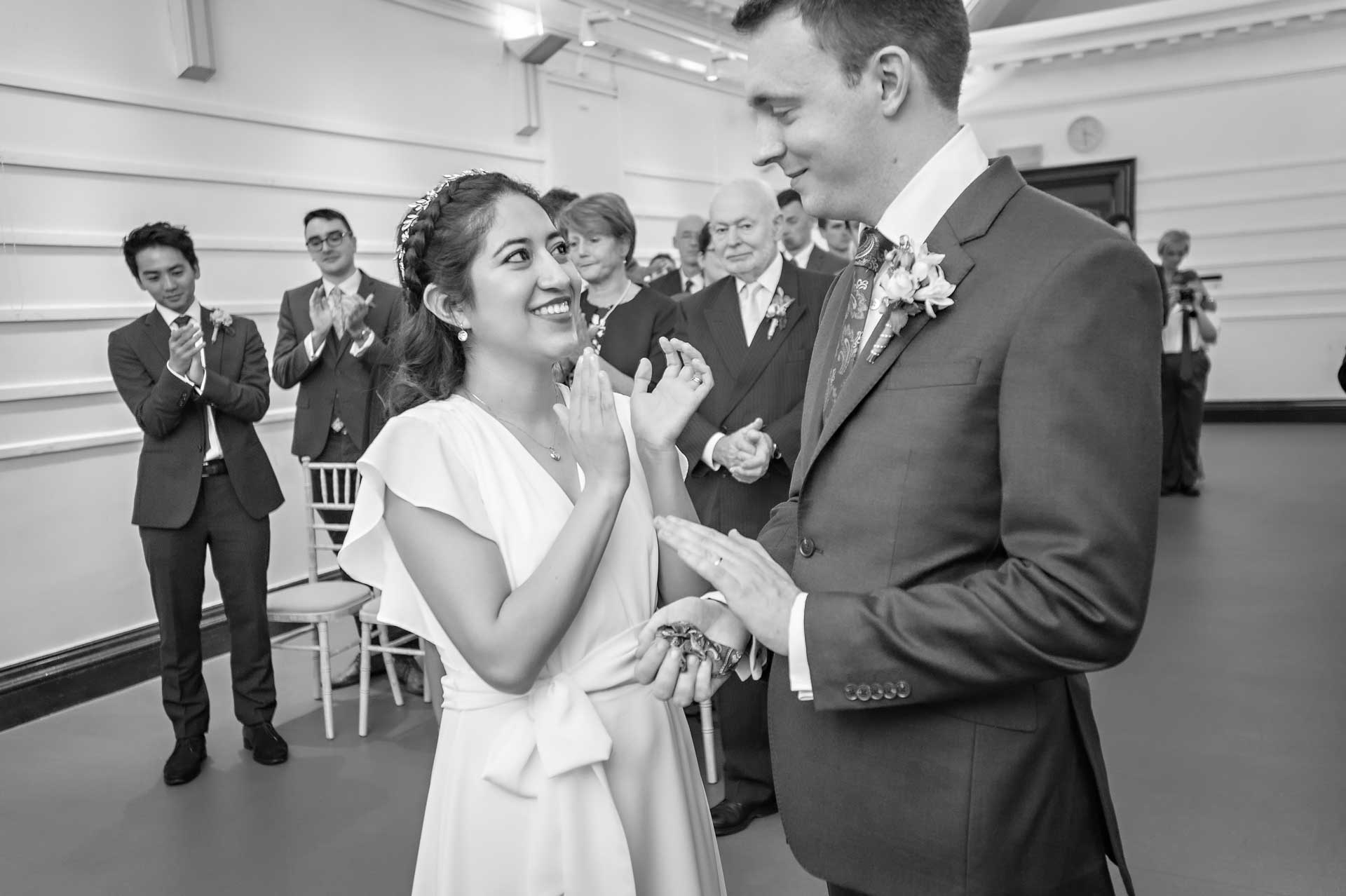 Newly-weds clapping after wedding vows at Fulham Library