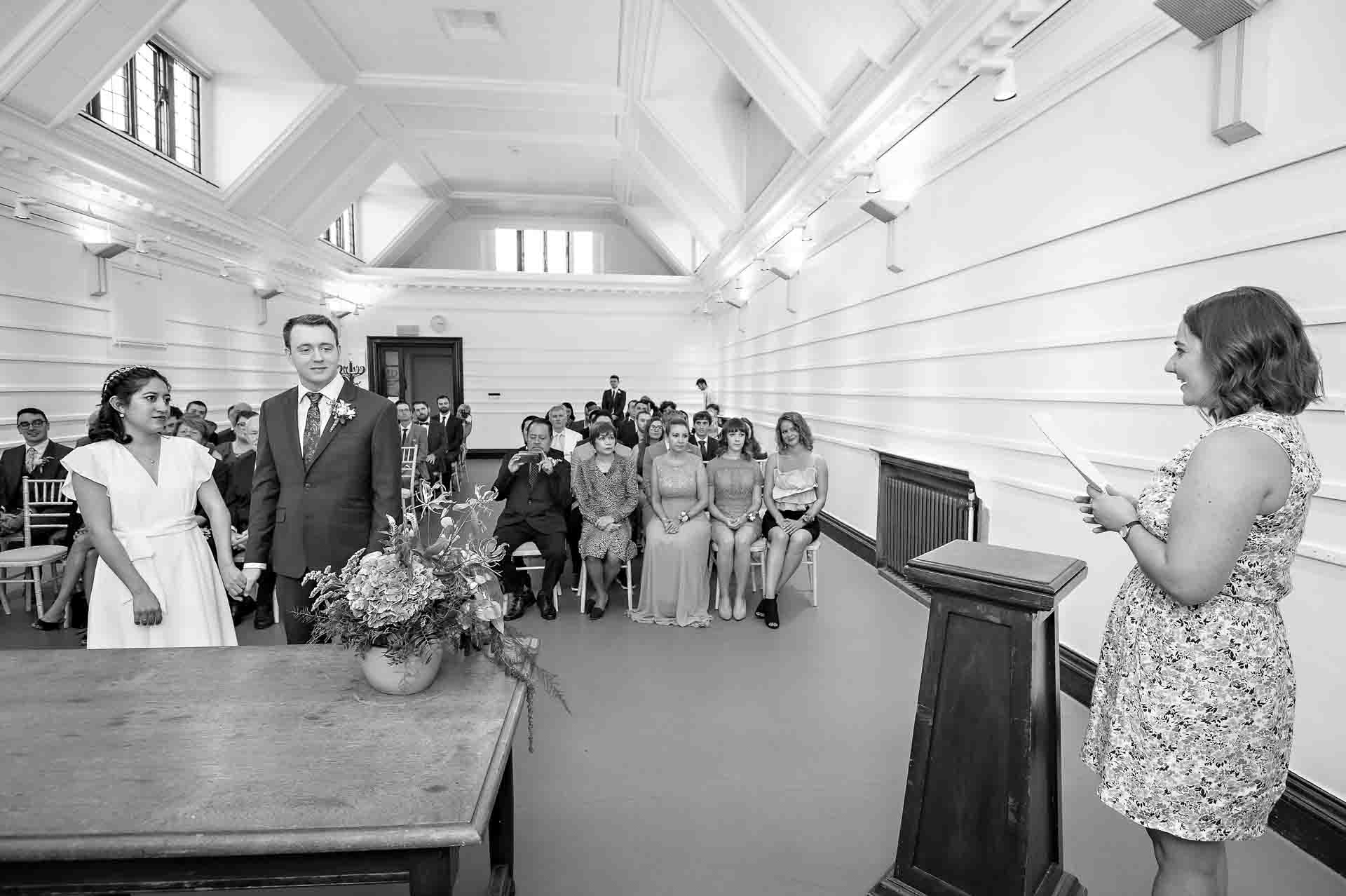 Female guest does reading at wedding in Fulham Library