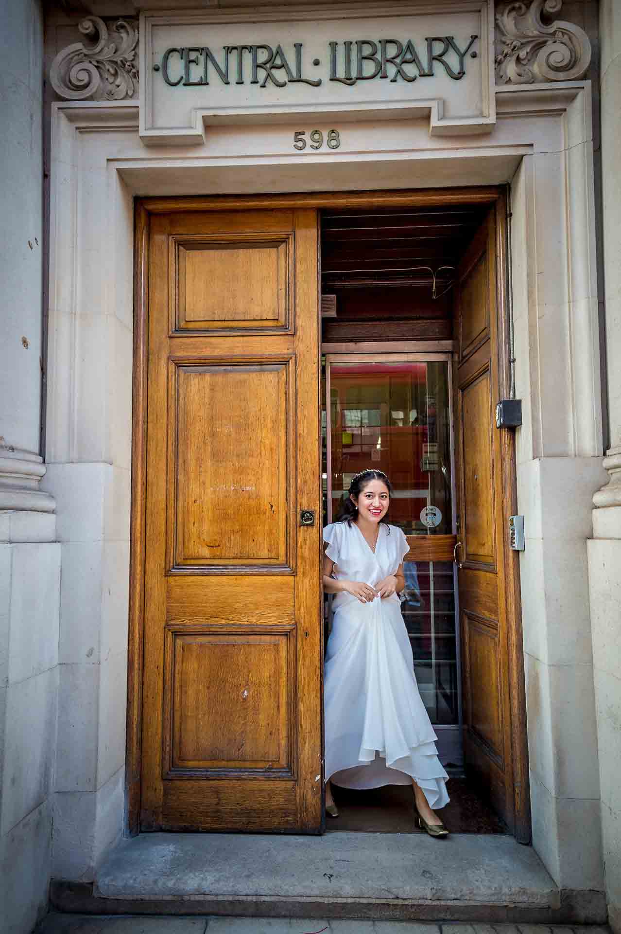 Bride leaves no. 598 Central Library Fulham after wedding ceremony