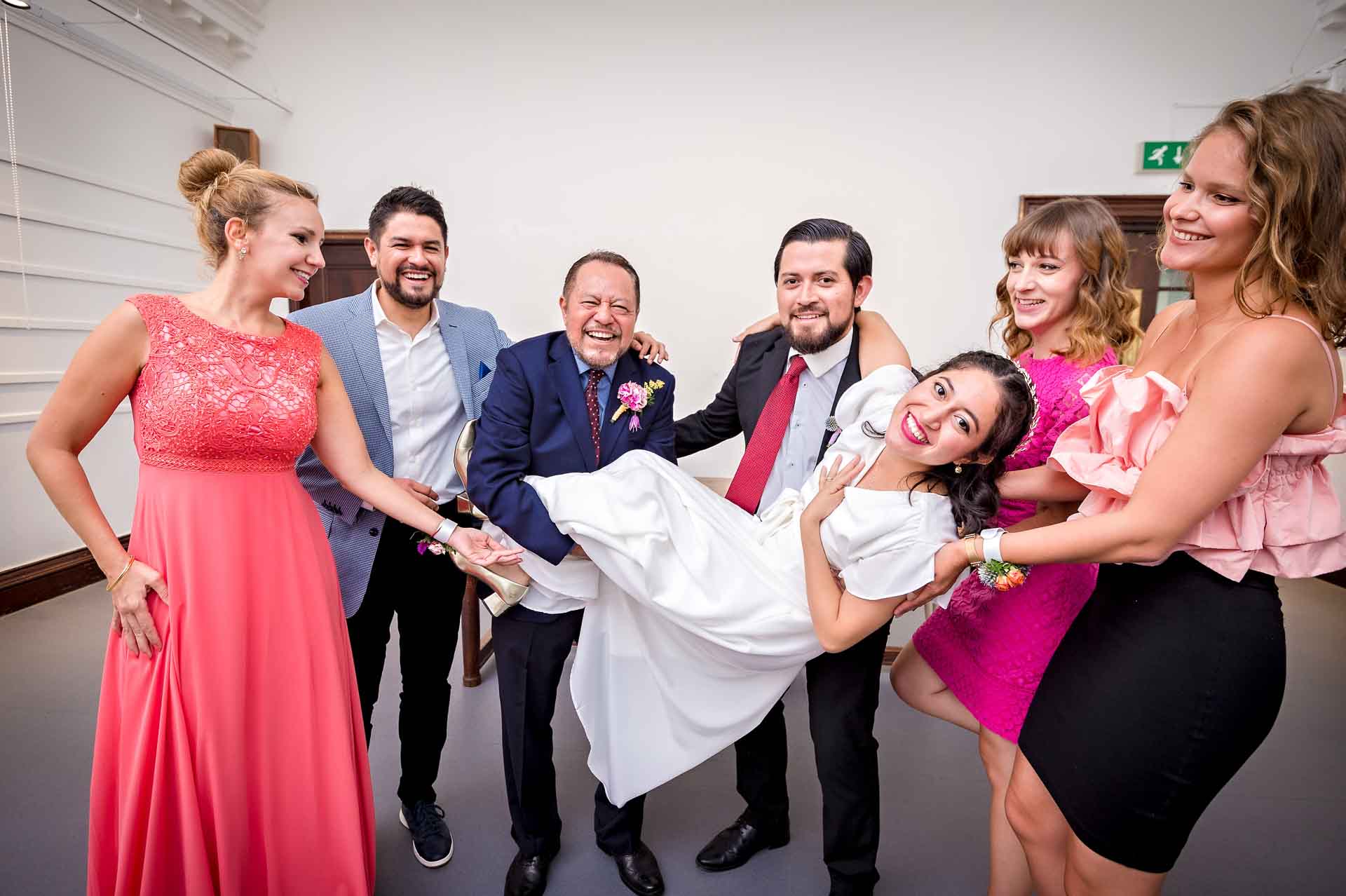 Guests holding bride in wedding at Fulham Library