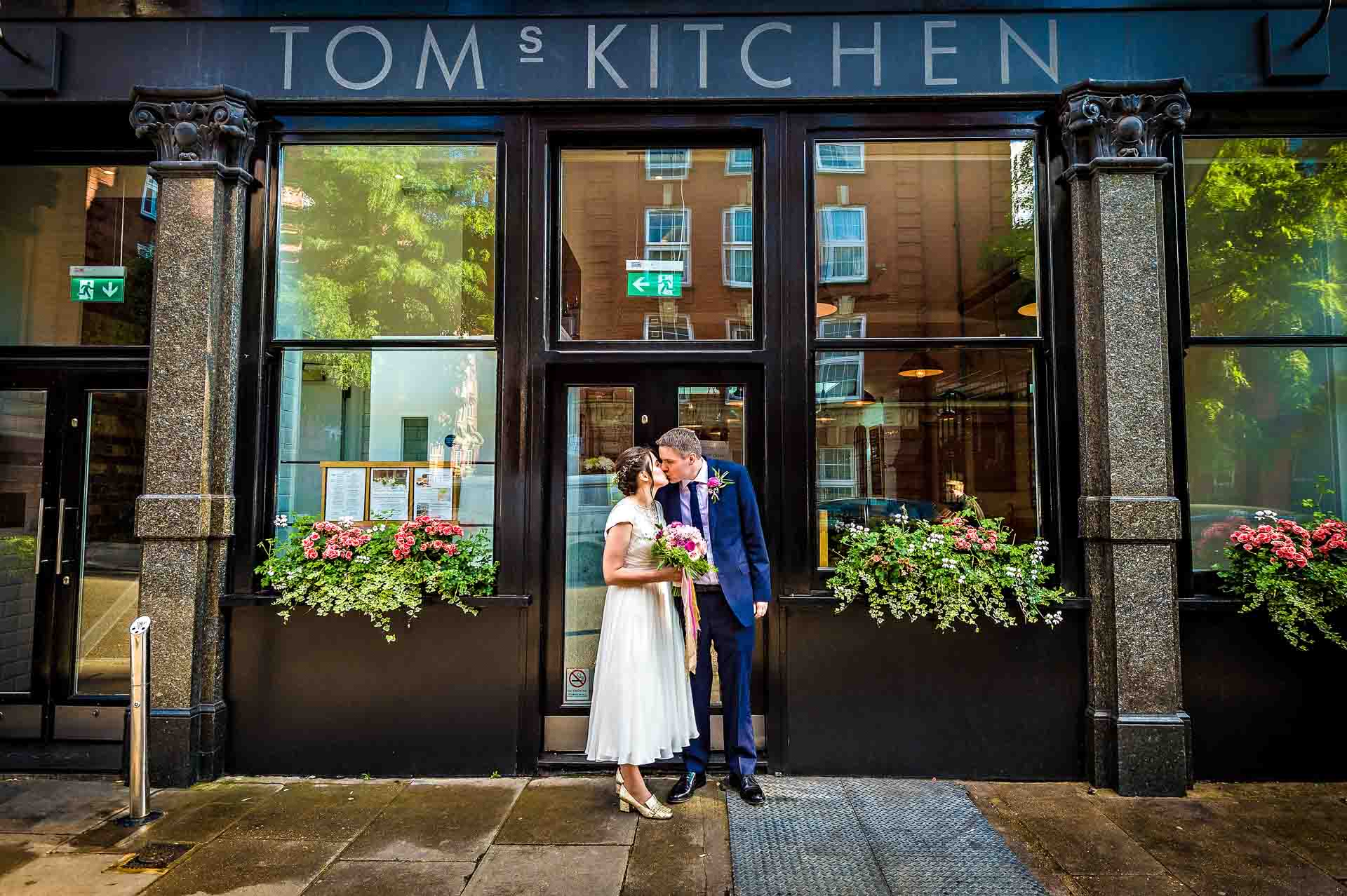 Wedding Couple Kissing Outside Tom's Kitchen