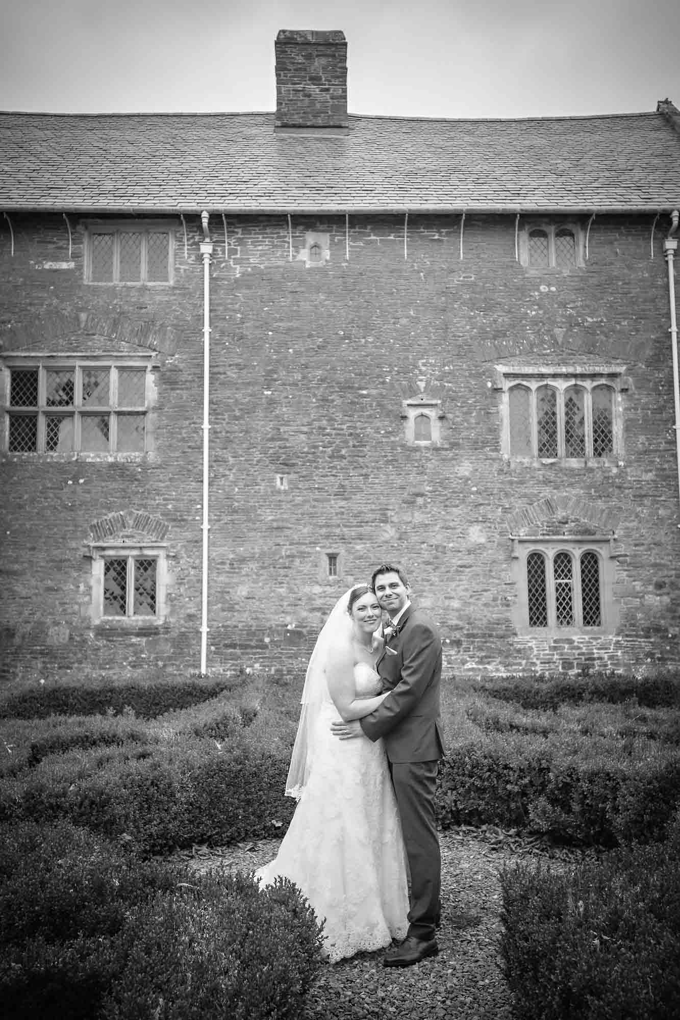 Happy bride and groom posing at Llancaiach Fawr Manor