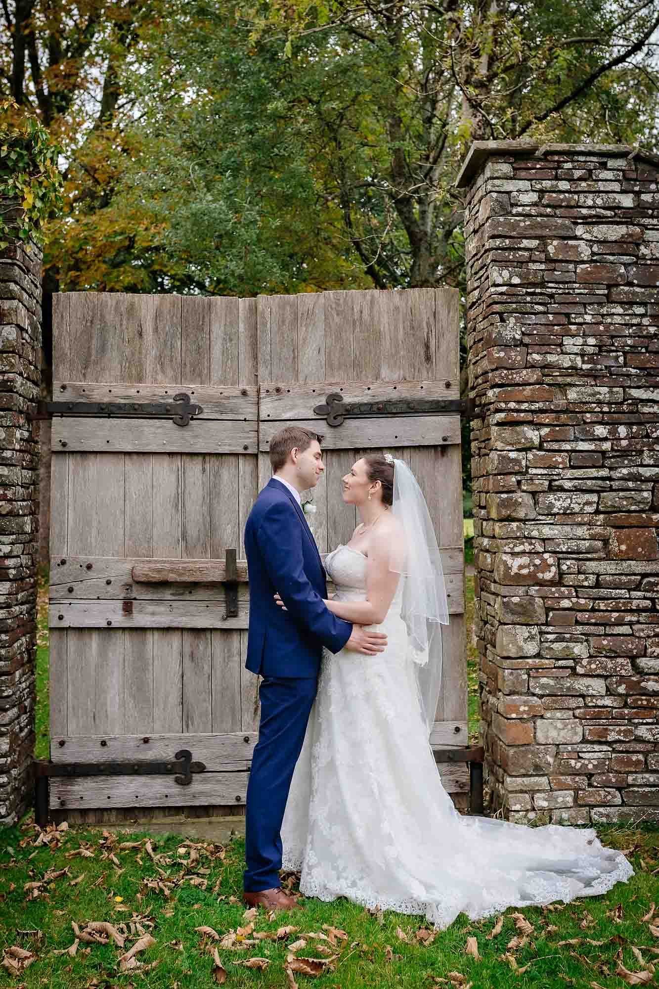 Married couple looking at each other with gate at Llancaiach Fawr Manor wedding