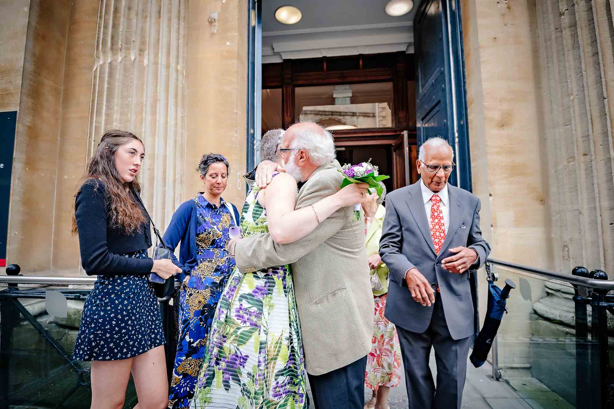 Father of bride hugs her at wedding outside Bristol Register Office