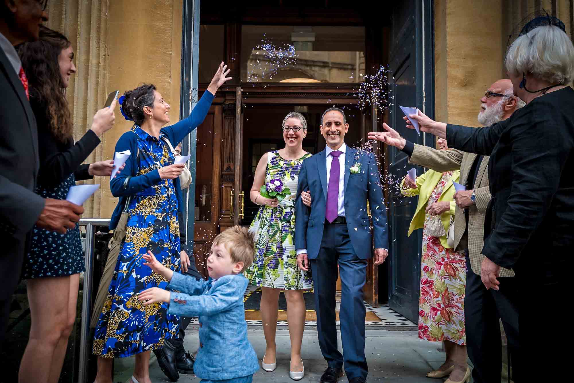 The couple exit Bristol Old Council house after wedding in shower of confetti