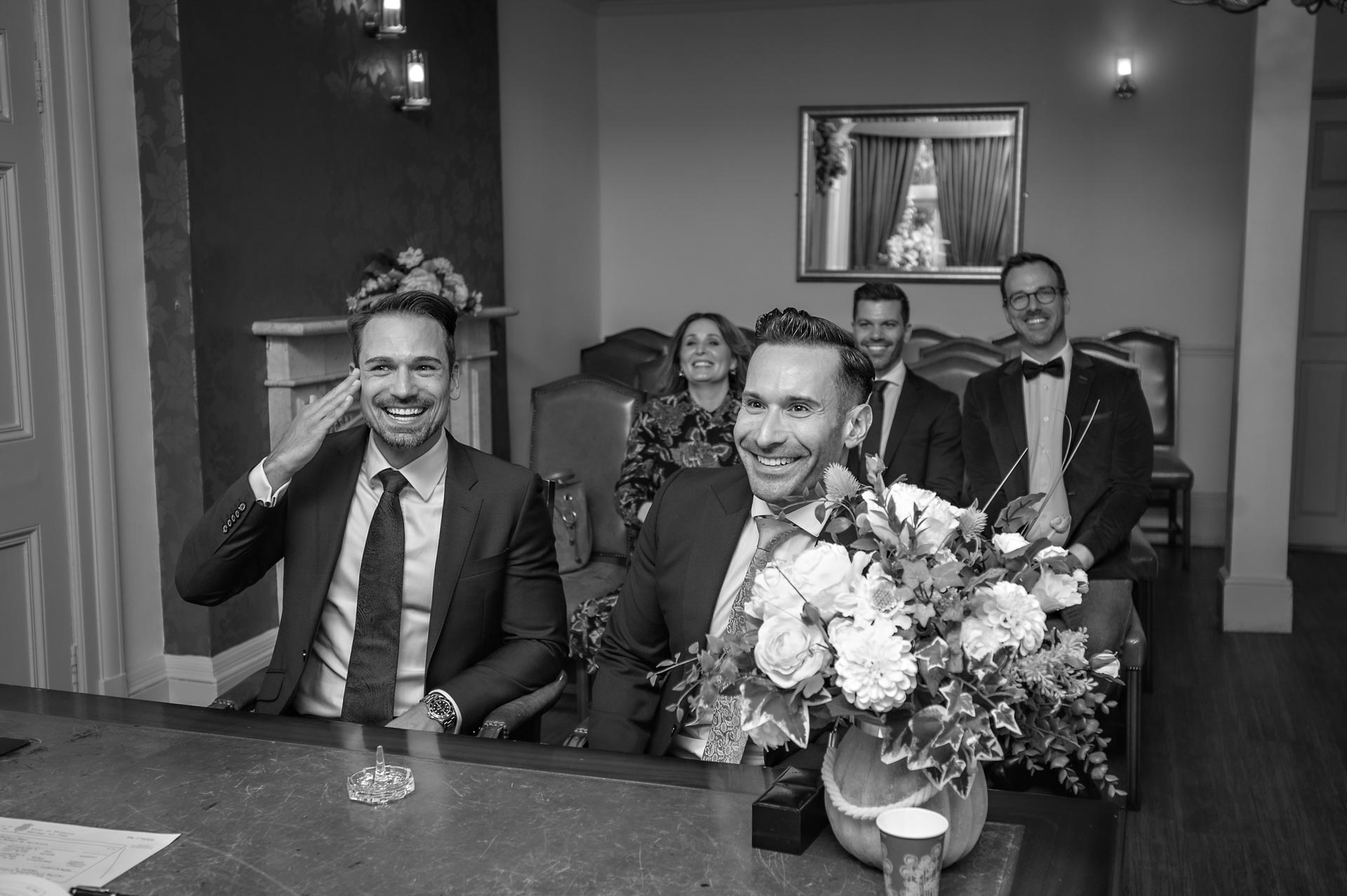 The grooms laughing at their same-sex Southwark Register Office wedding