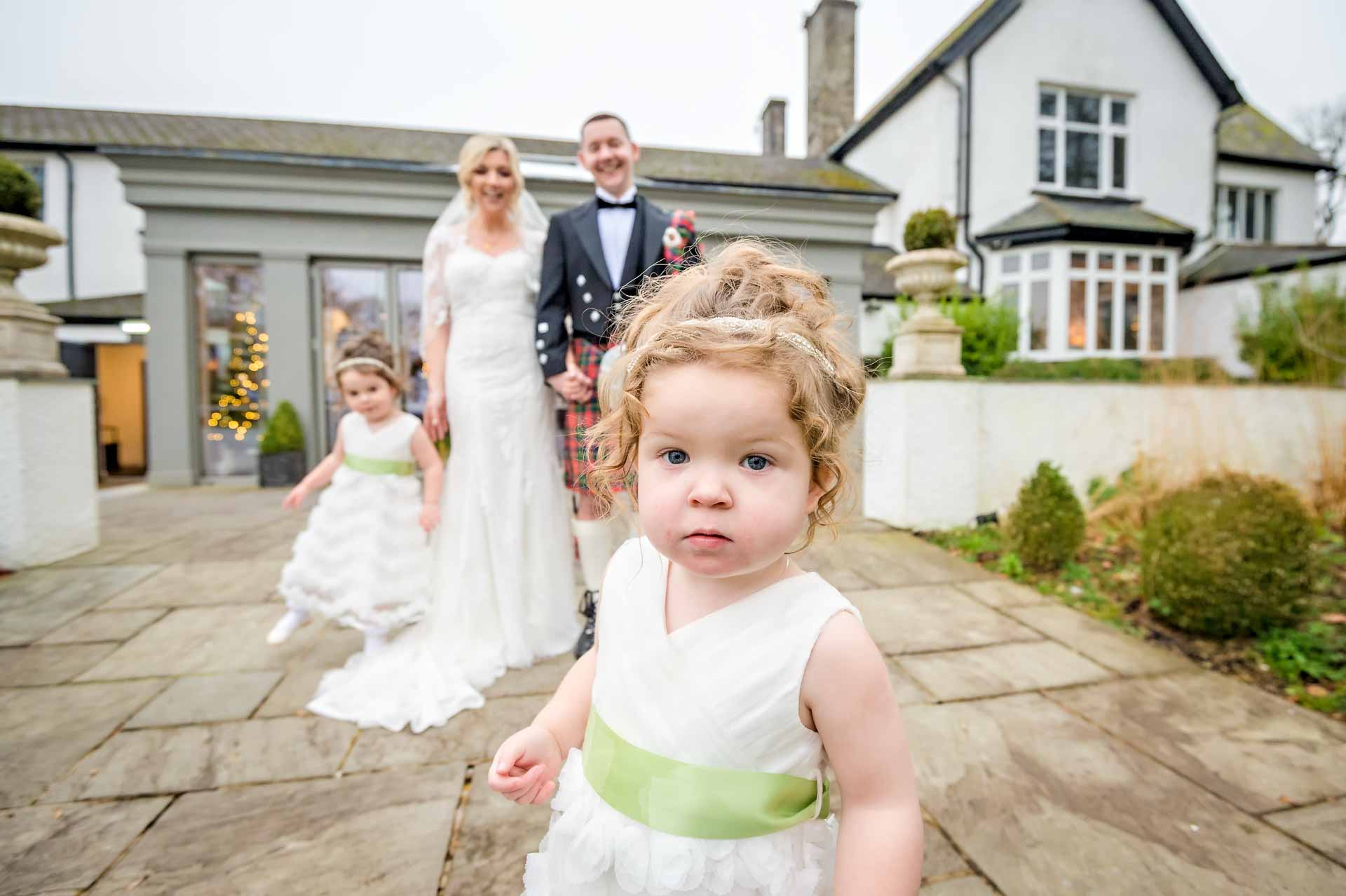 Wedding couple's daughter approaches the camera during the posed family shots.