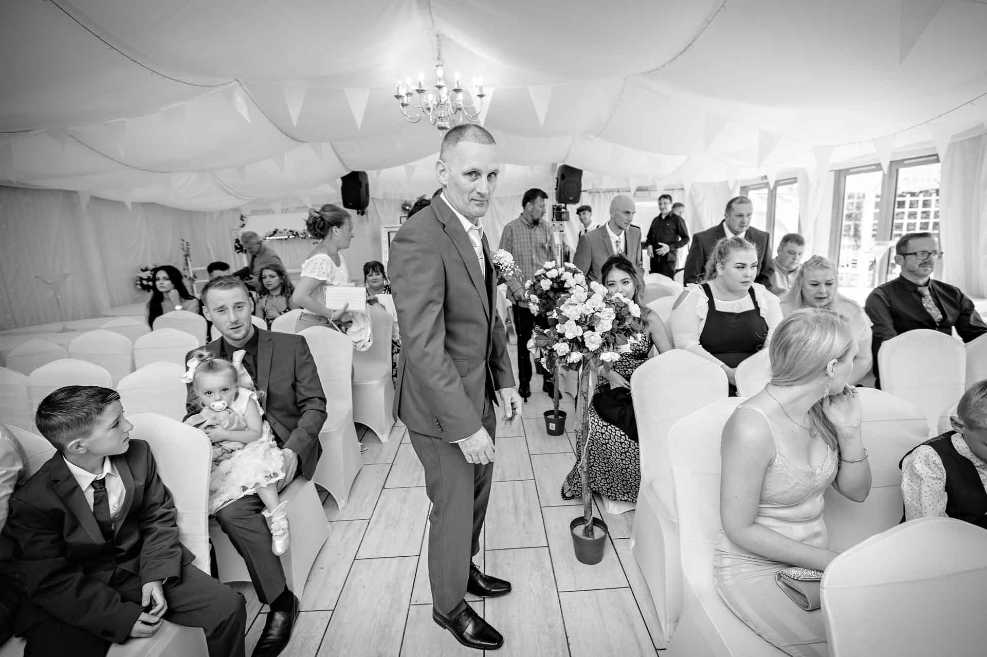 The groom stands nervously in the centre of the Marquee at the Ridgeway Golf Club in Caerphilly