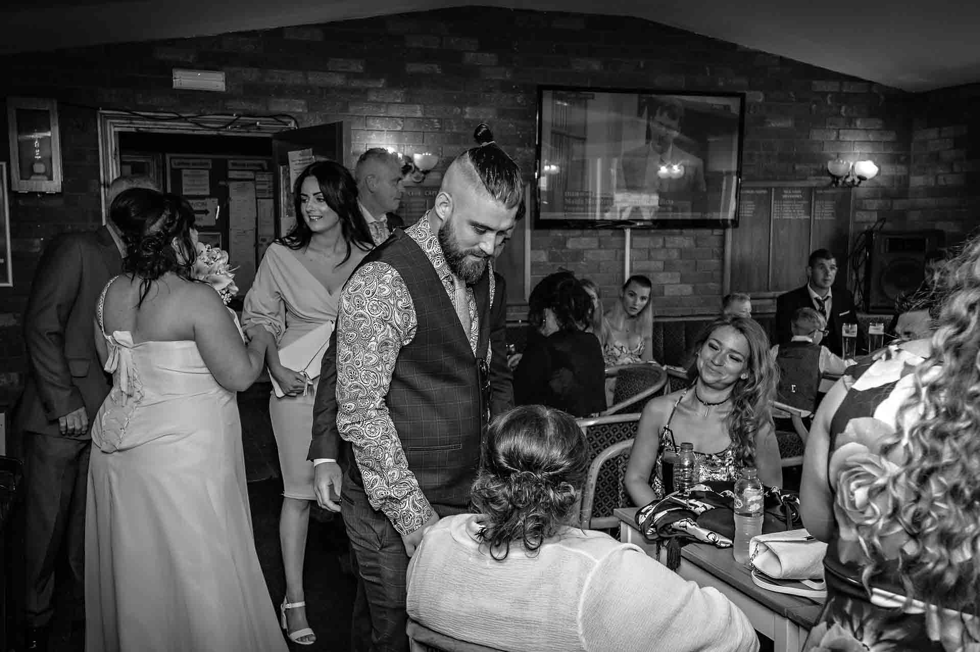 Guests mingle in club house after wedding at the Ridgeway Golf Club in Caerphilly