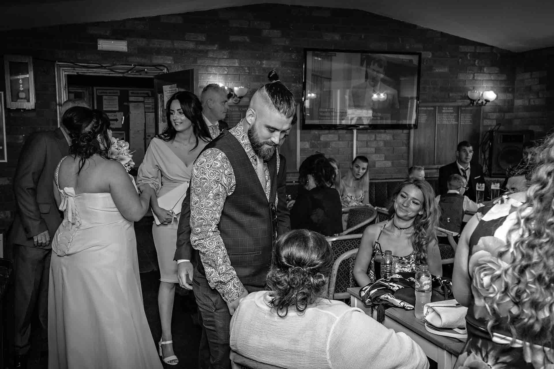 Guests mingle in club house after wedding at the Ridgeway Golf Club in Caerphilly