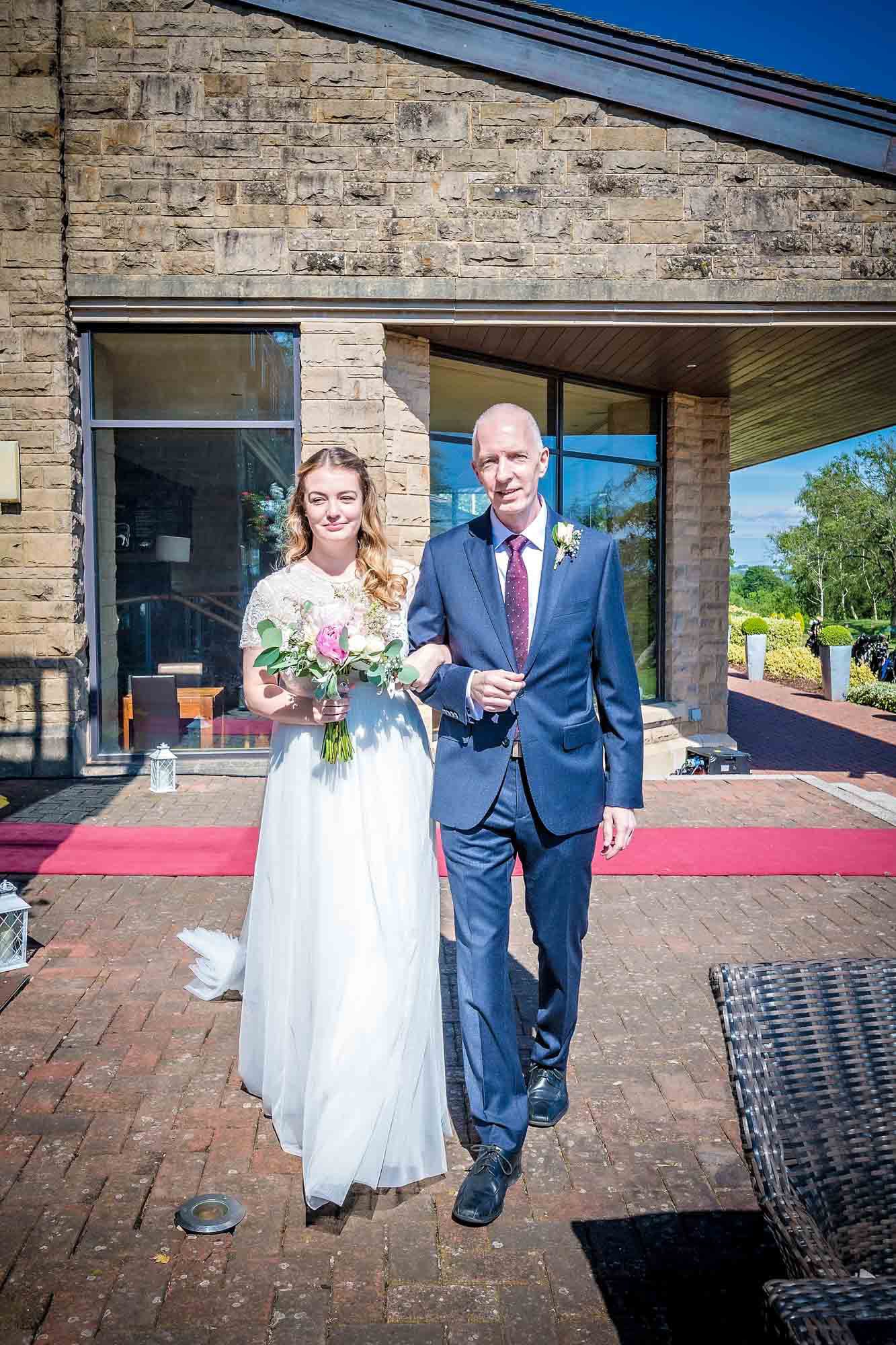 Father escorts his bride daughter to her wedding ceremony at Celtic Manor Resort