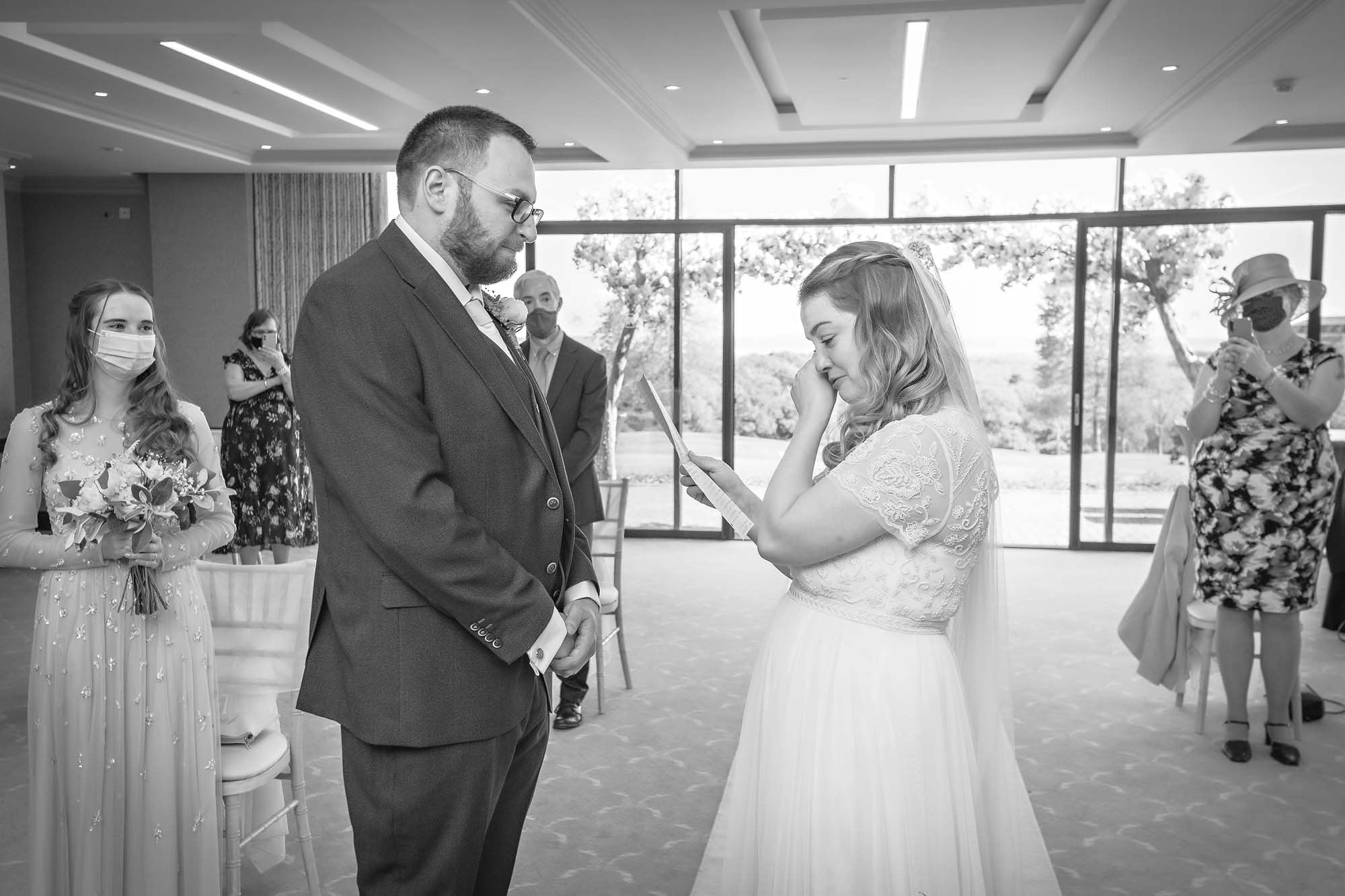 The bride is tearful as she reads to her groom at a Newport wedding