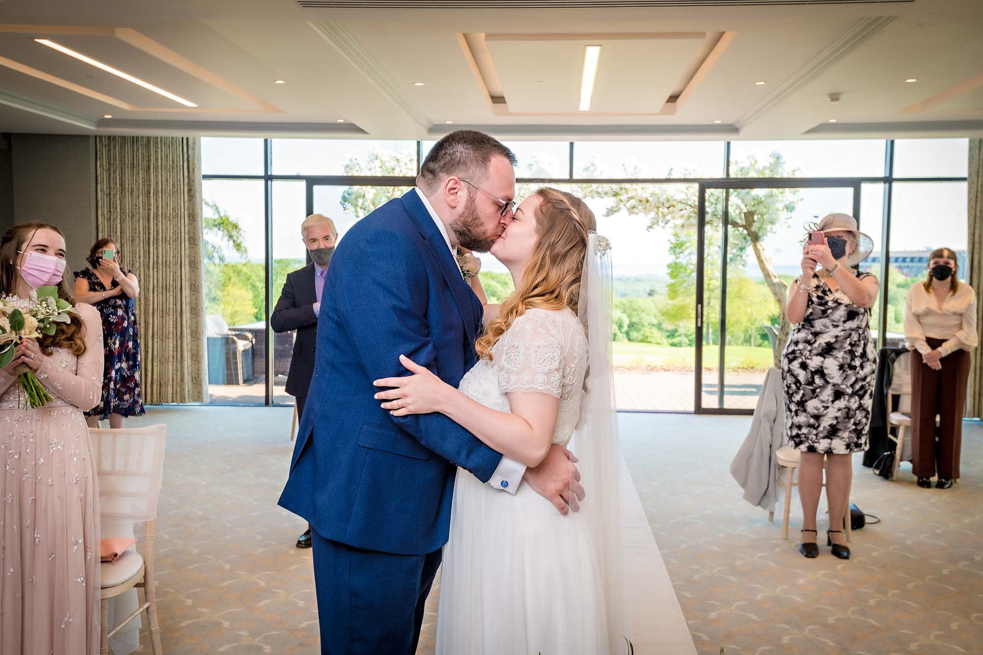 The bride and groom share their first kiss in the Via Julia Suite at Celtic Manor Resort, Newport