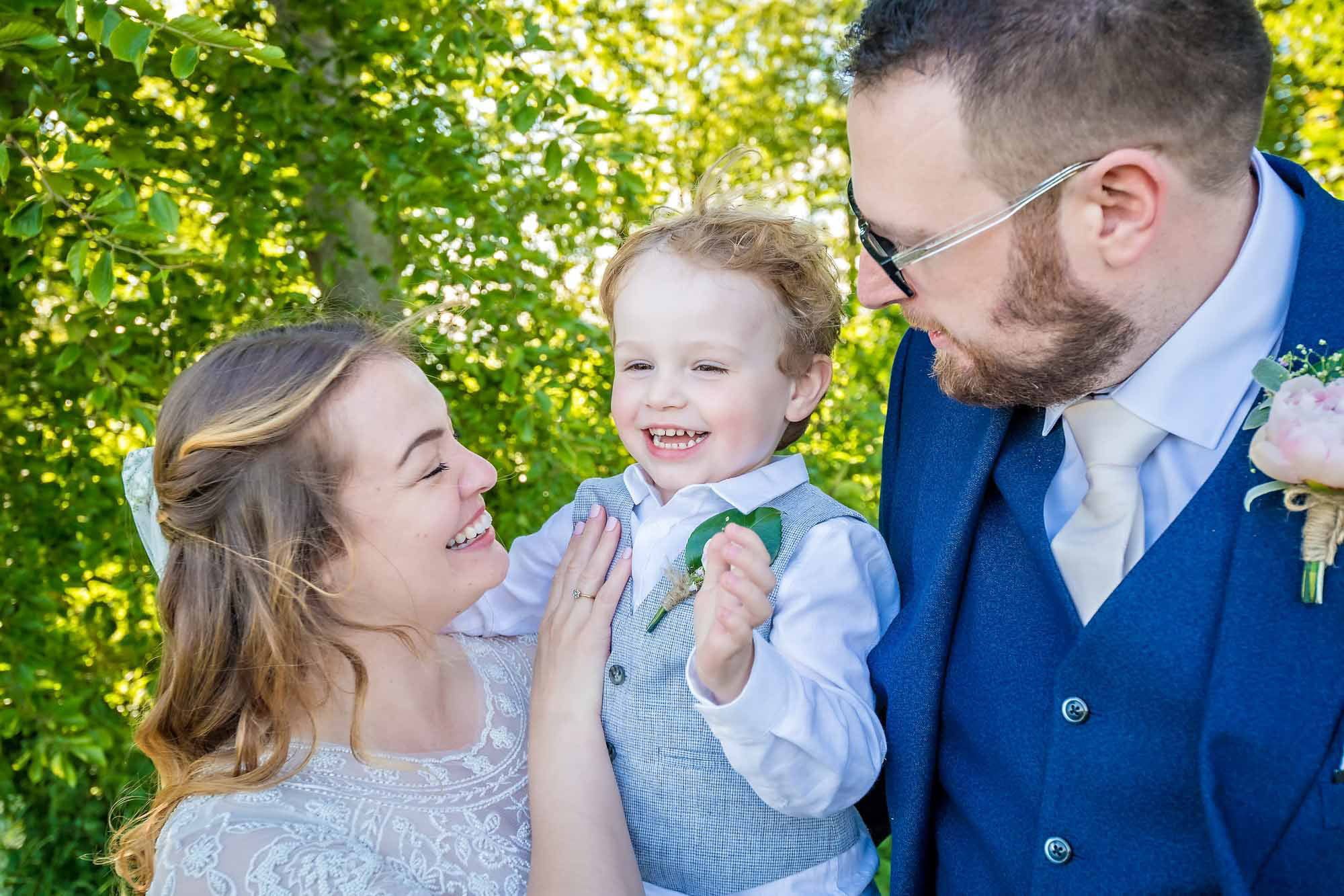 Newlyweds with their little boy at wedding