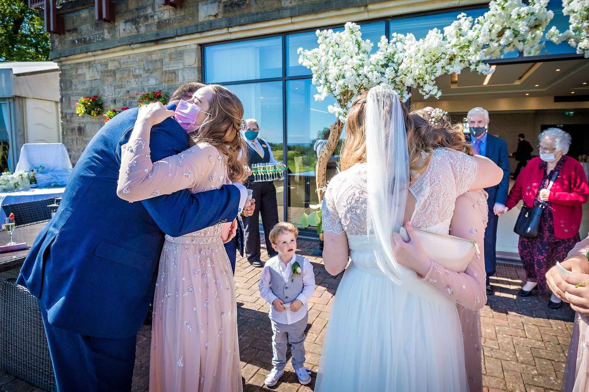 The newlyweds hug guests after their wedding ceremoiny at Celtic Manor Resort