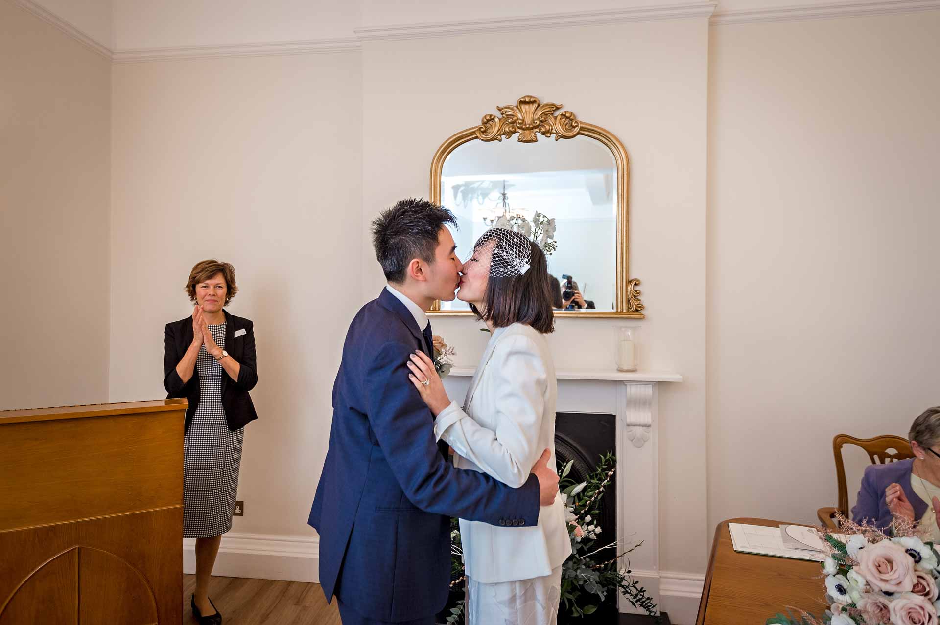 The bride and groom have their first kiss at their Woolwich Town Hall Wedding in London