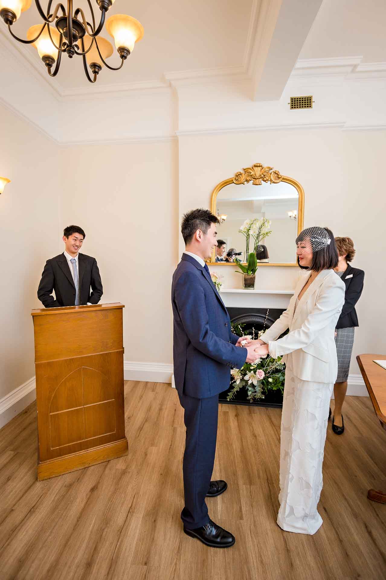 A male guest gives a reading whilst the couple hold hands at a Woolwich Town Hall Wedding