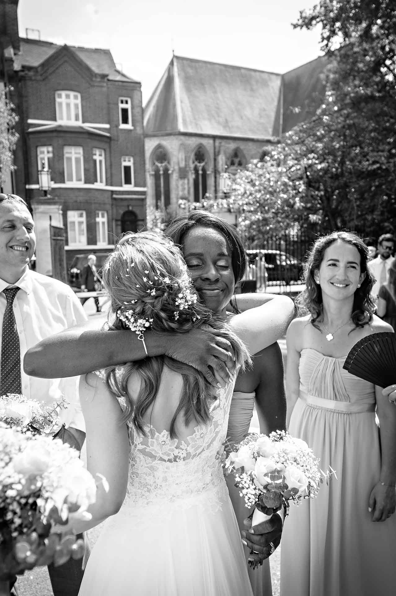 Bridal Portrait Morden Bride Hugging Bridesmaid after Wedding Ceremony