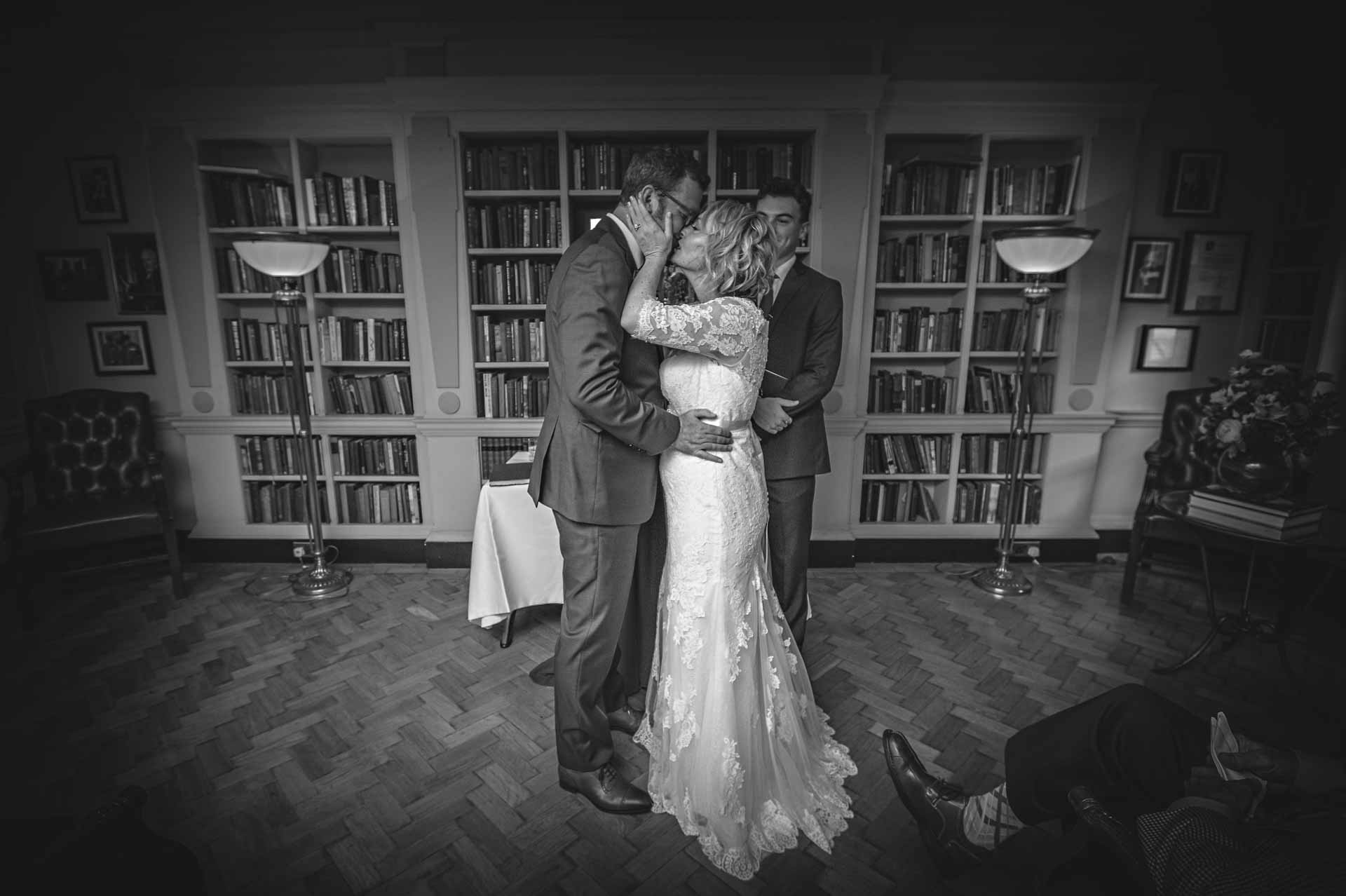 Bride holding groom by cheek and kissing at Bloomsbury Hotel wedding