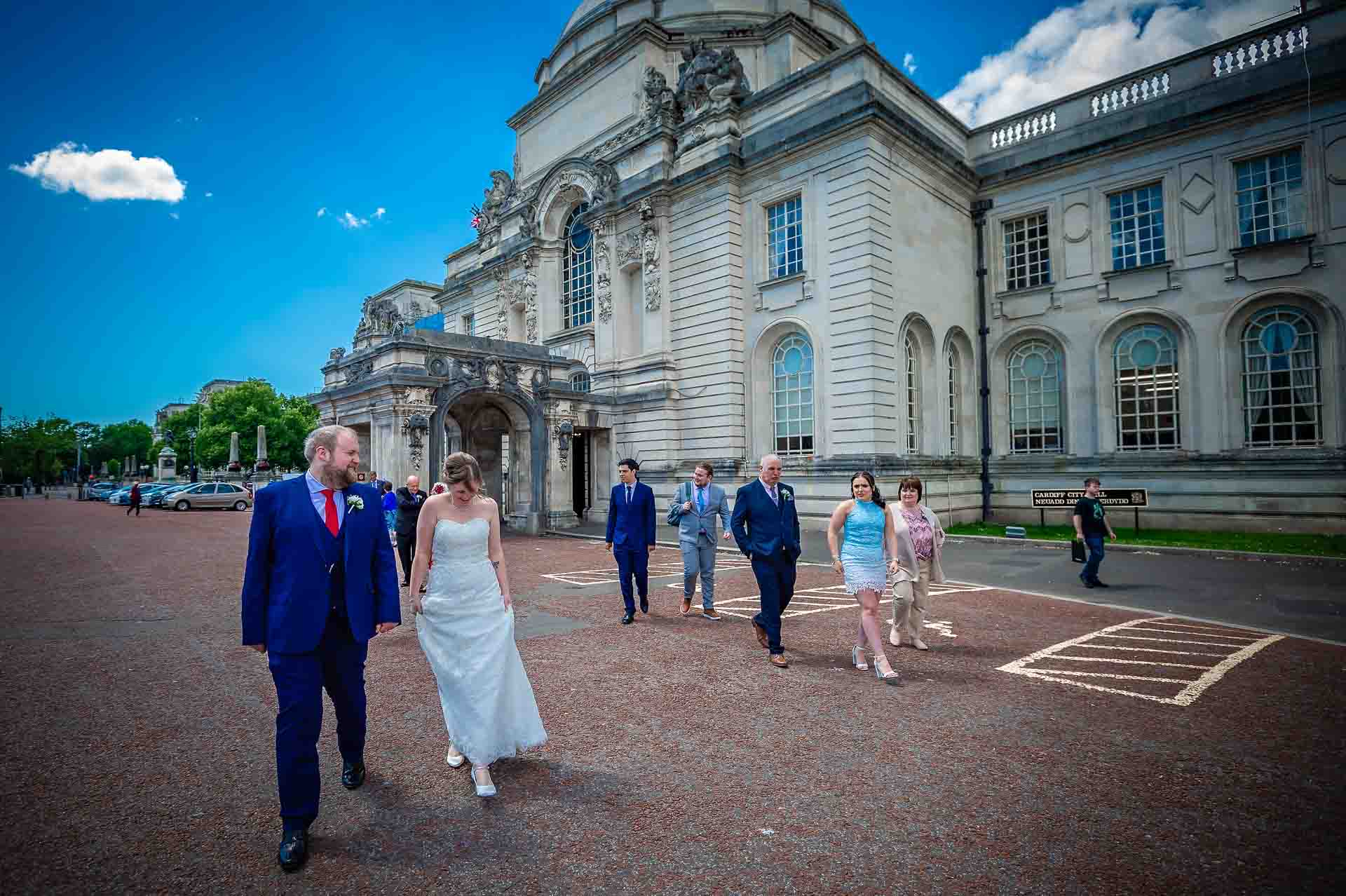 Bridal party walking away from City Hall in Cardiff after wedding