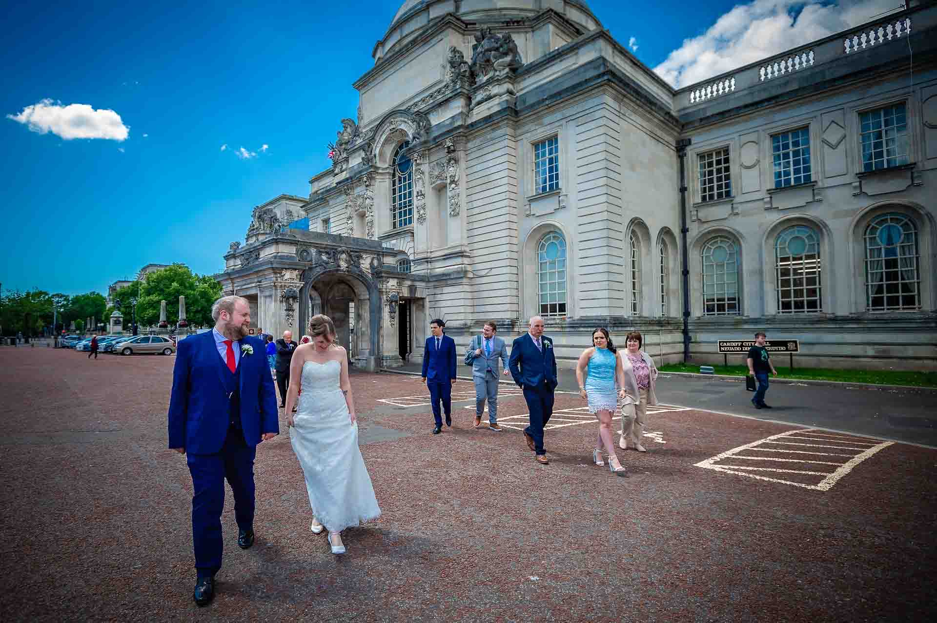 Bridal party walking away from City Hall in Cardiff after wedding