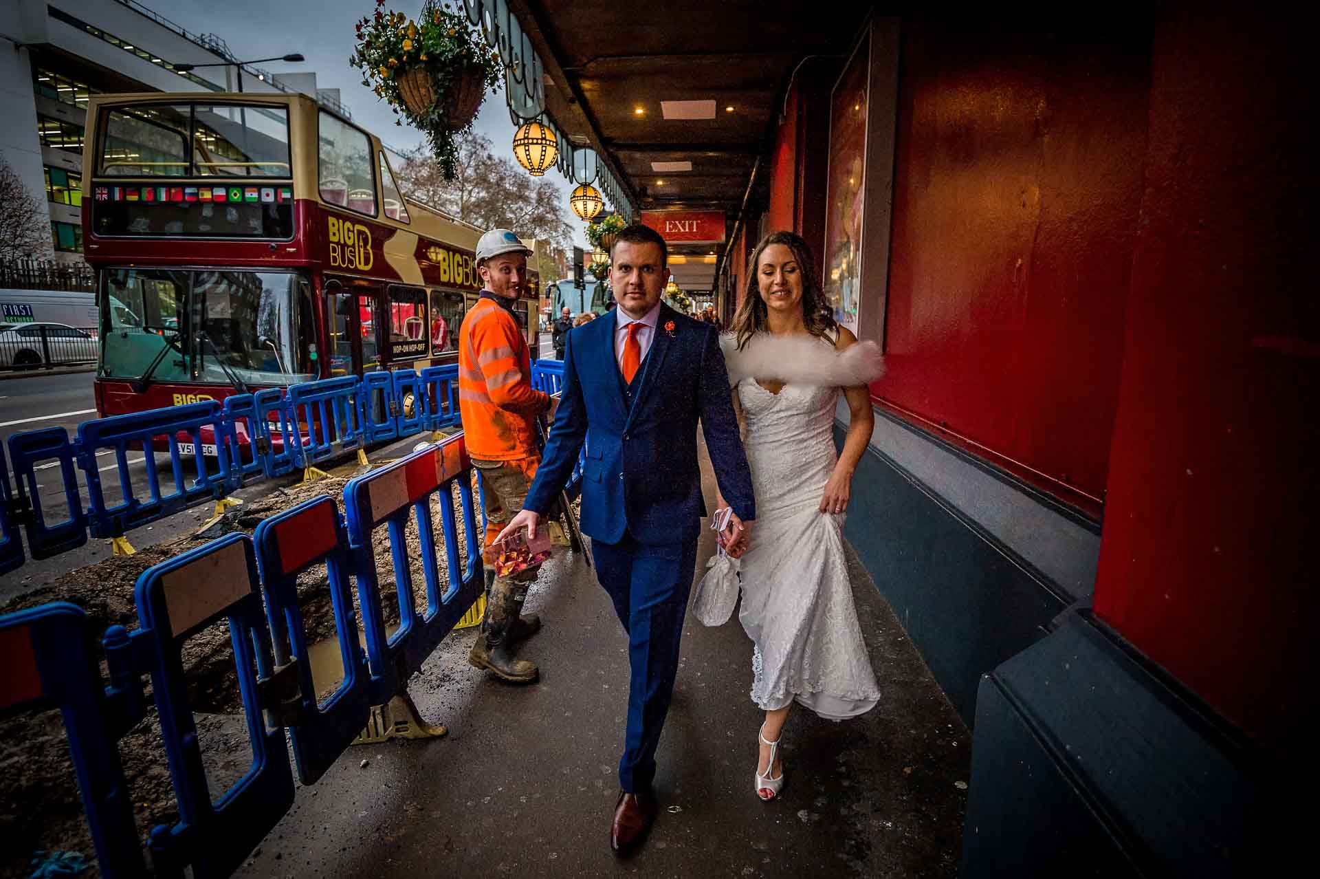 Married Couple Walking Past Roadworks Outside Madame Tussaud's in London