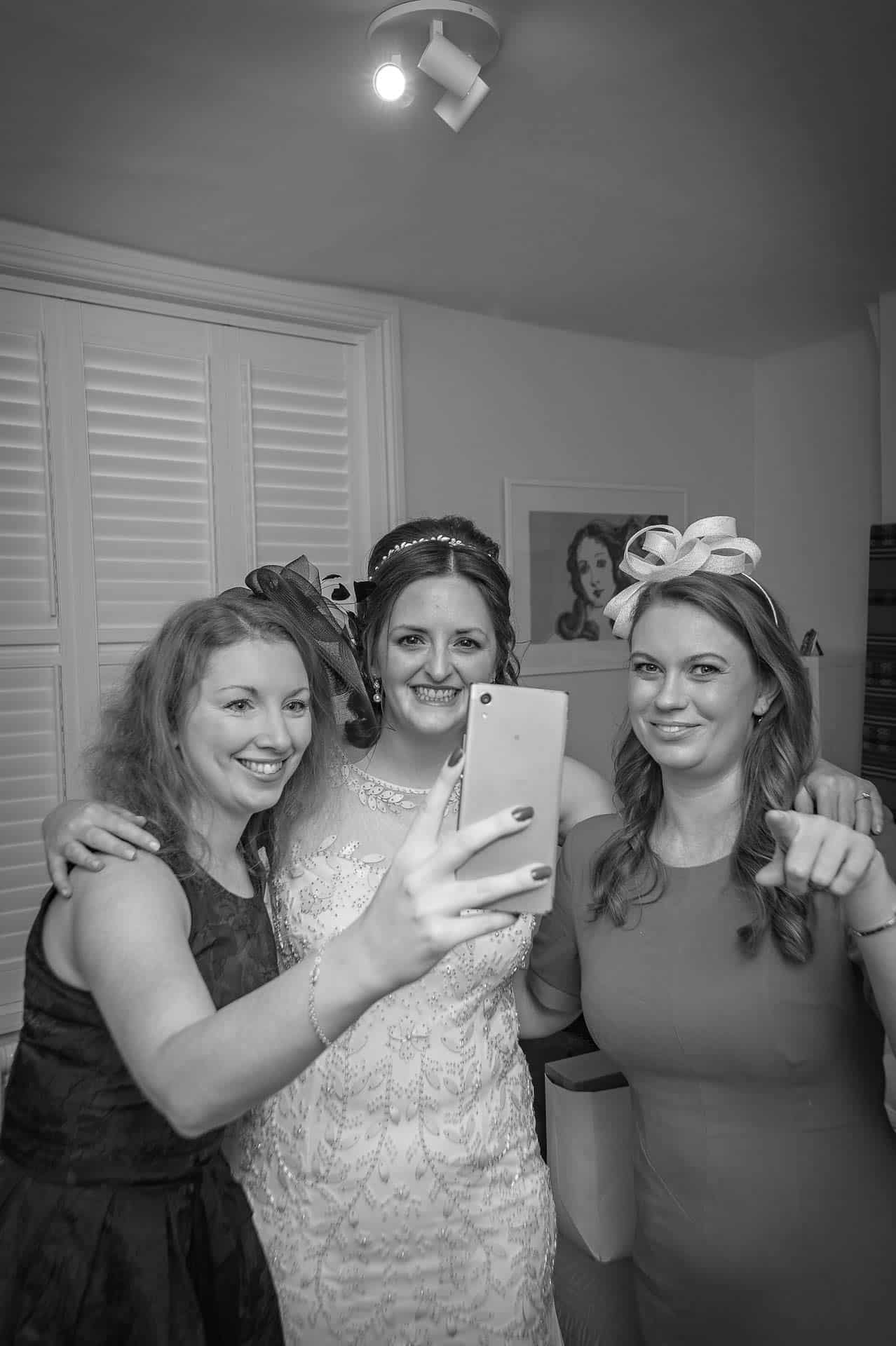 Bride with fiends taking selfie at preparations