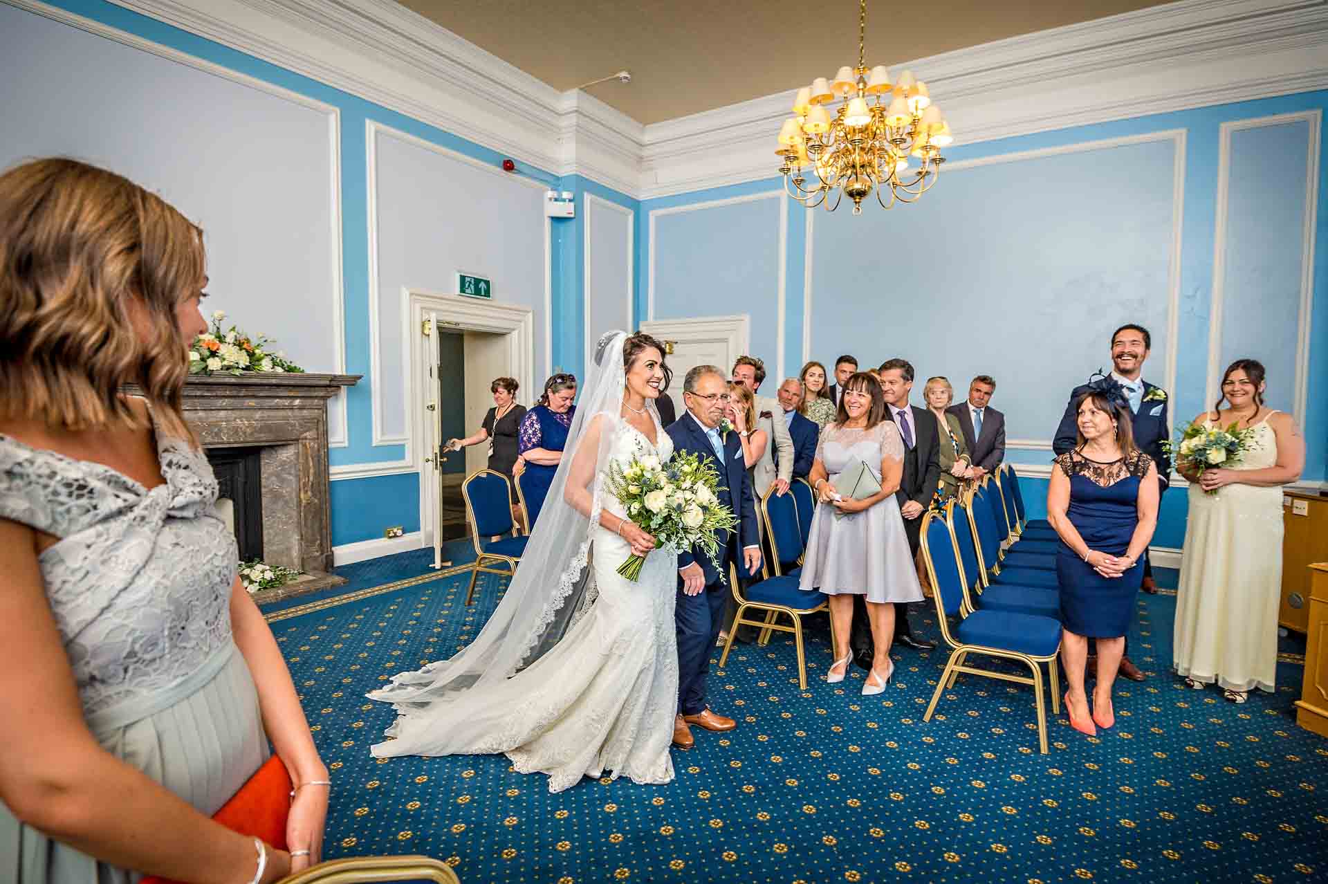 Bride walks into st David's room at Cardiff City Hall with her father