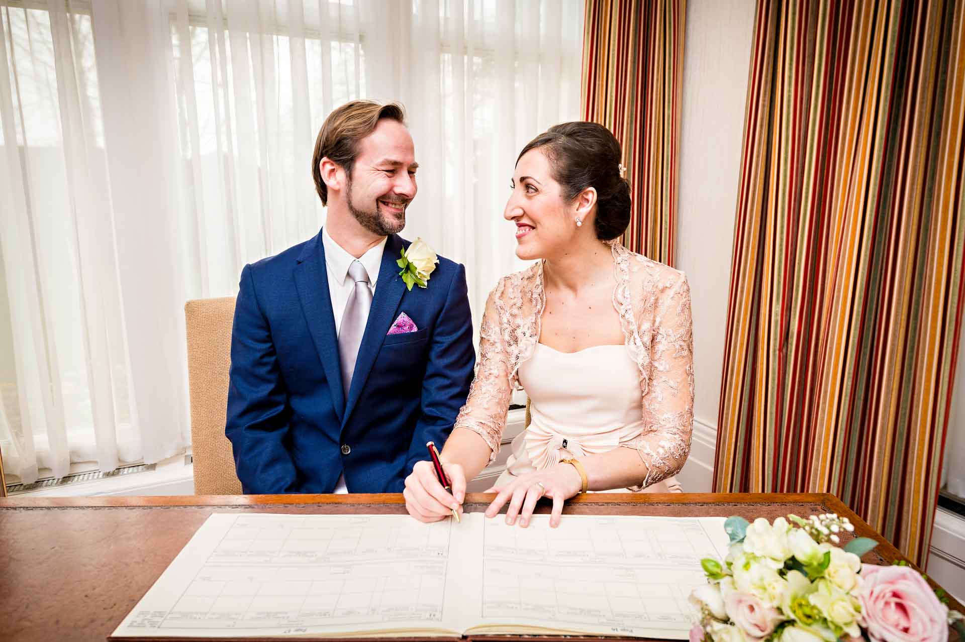 Dummy Wedding Register Signing with Couple Looking at Each Other