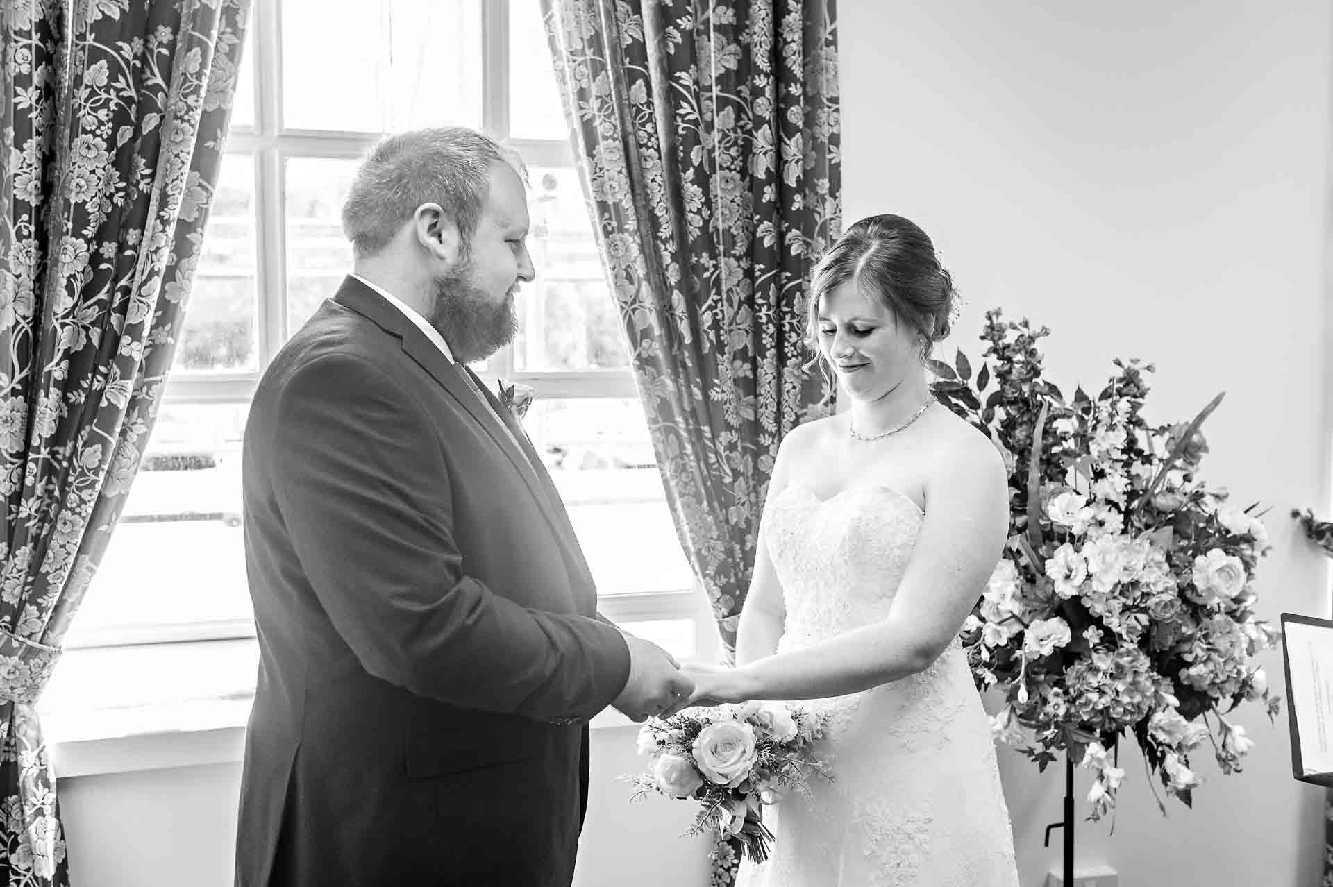 Bride and Groom holding hands at rings exchange