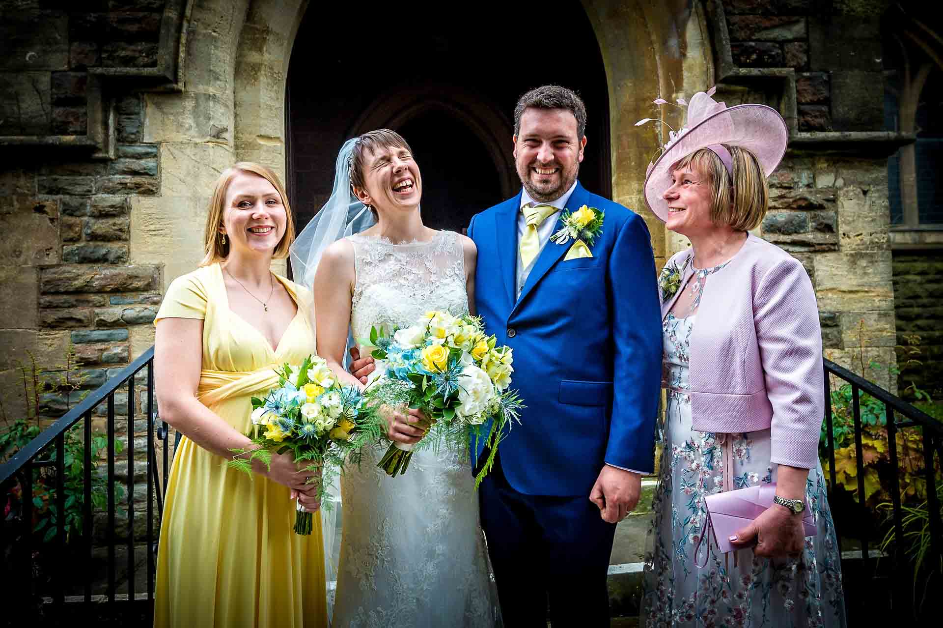 Family Group Portrait Outside Church Door with Bride Laughing