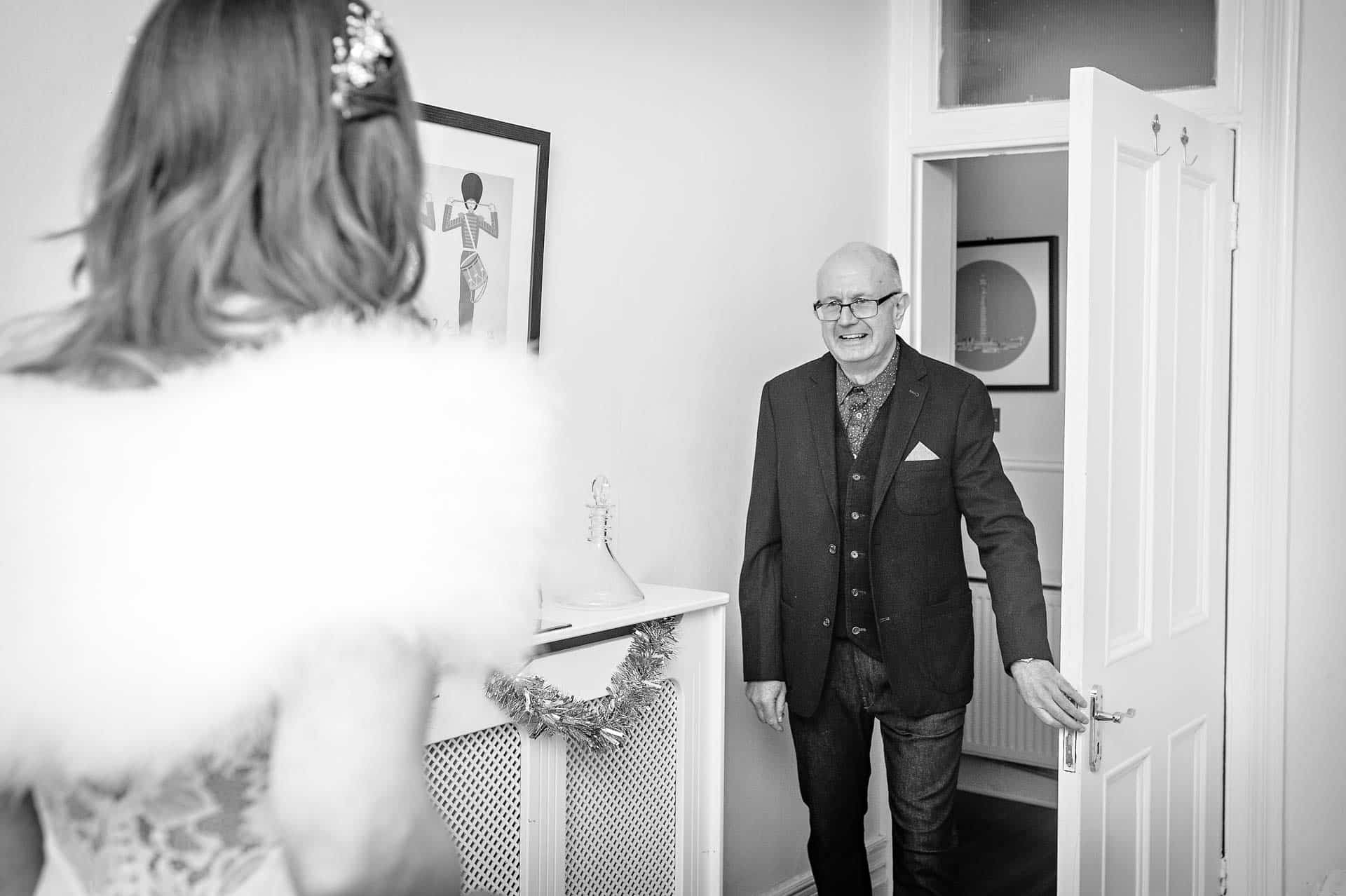 Father of bride sees her in her dress for the first time
