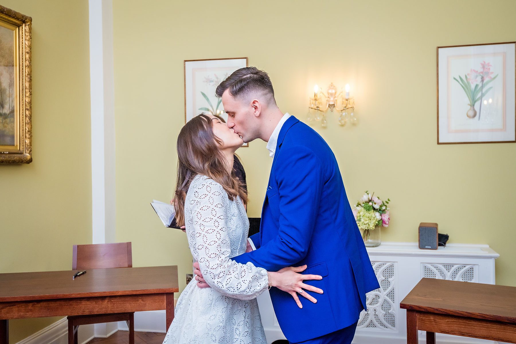 Couple having their first kiss in the Rossetti Room at Chelsea Old Town Hall