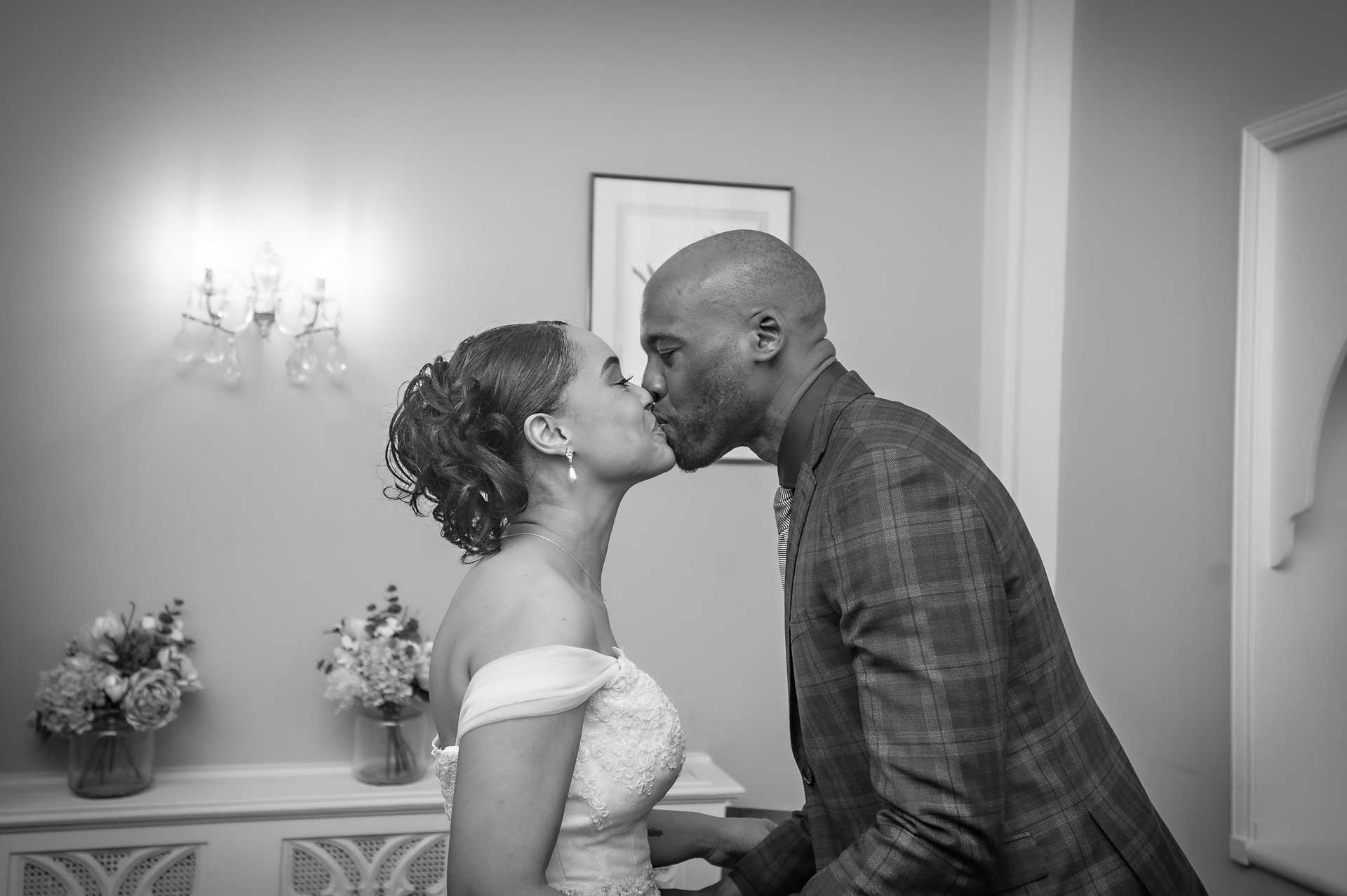 The bride and groom kiss as they are married at Chelsea Old Town Hall