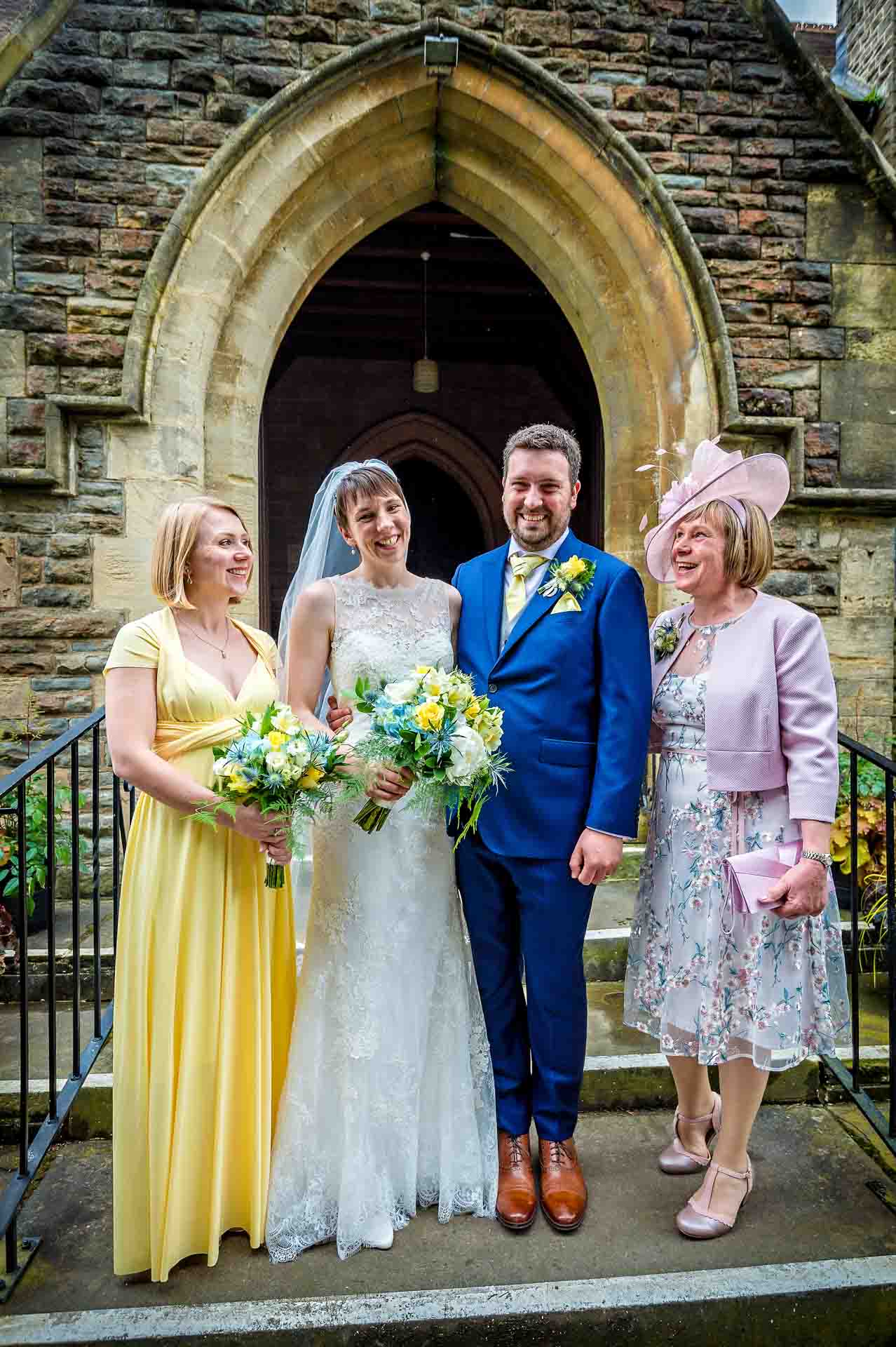 Couple with bride's mum and sister outside entrance door of St Martin's Church in Caerphilly