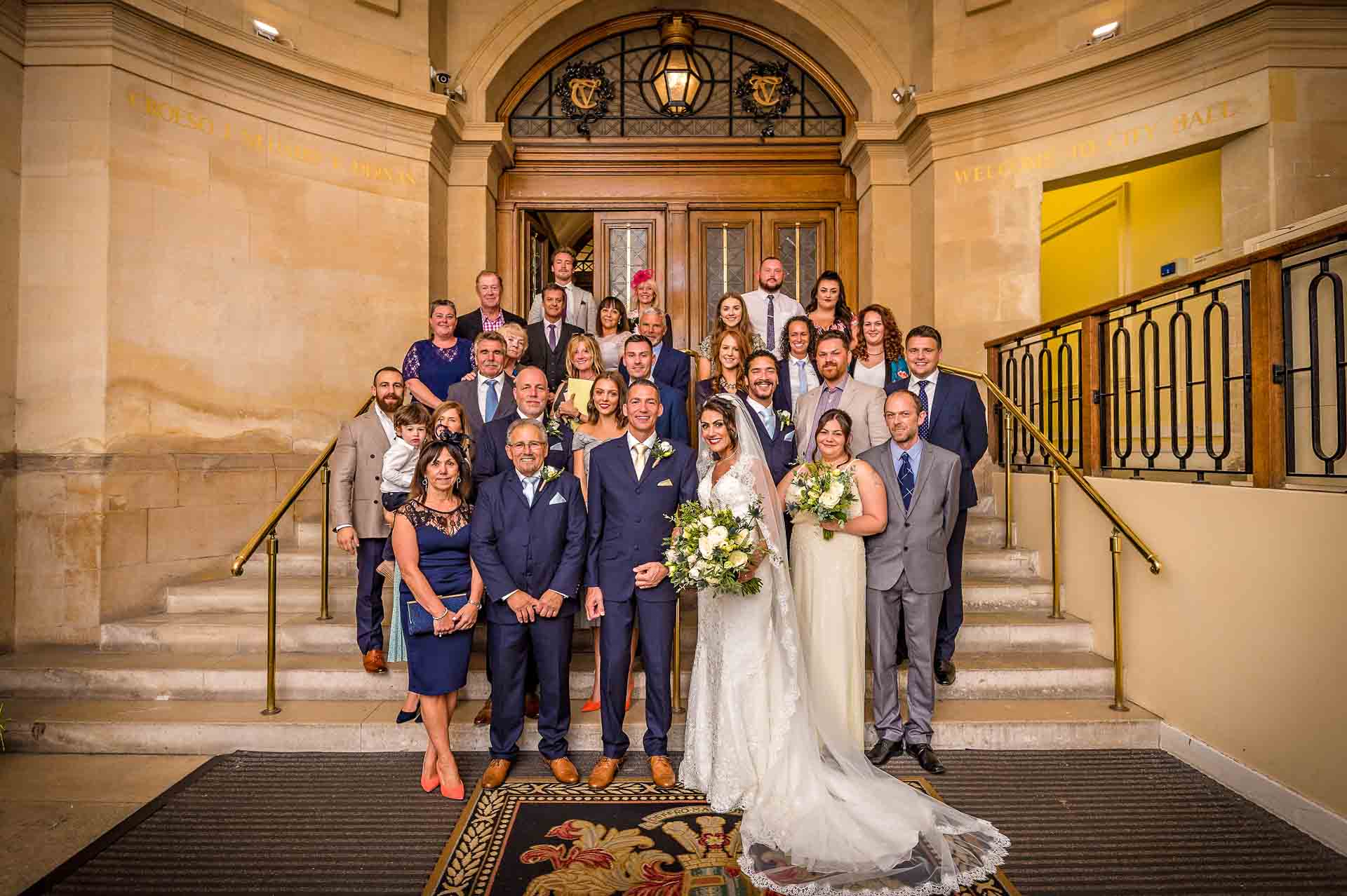 Group wedding portrait taken in entrance hall of Cardiff City Hall