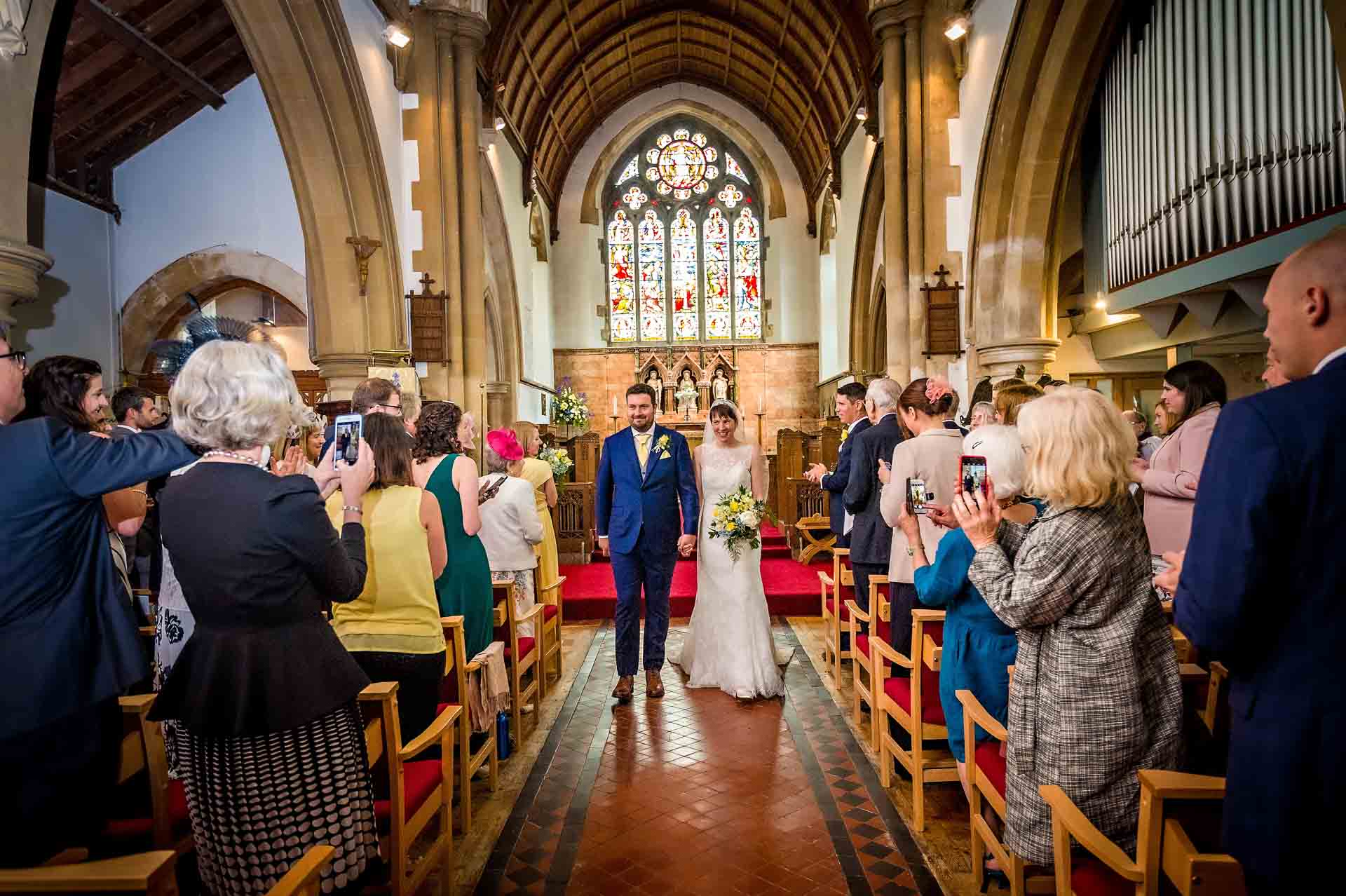 Newly Weds Walking Down the Aisle after their wedding ceremony