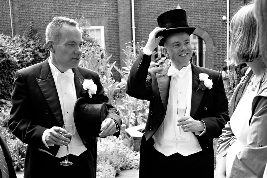 Gay Wedding Couple with Top Hats Chatting to Guests