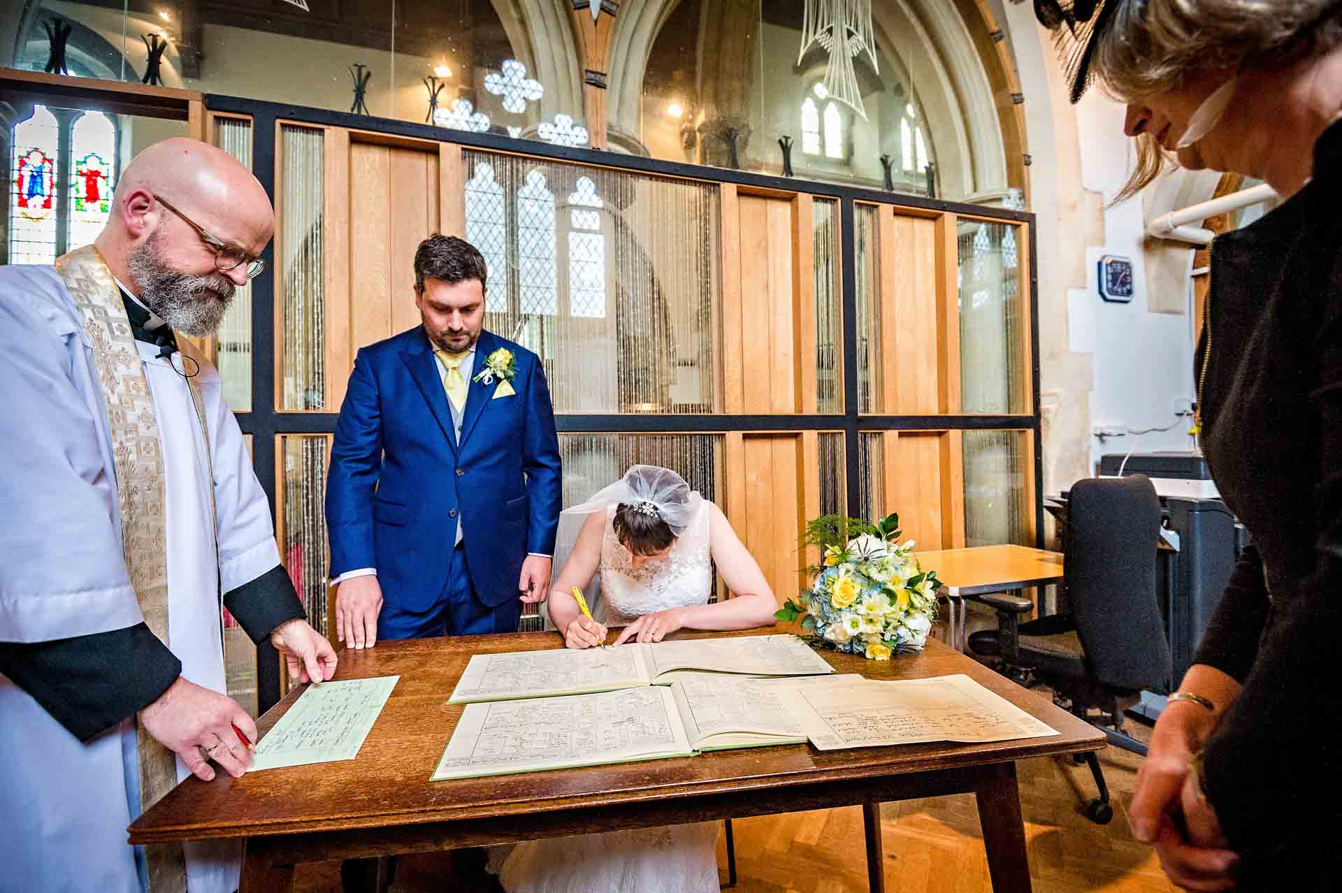Signing of the Register at Church in South Wales with vicar looking on