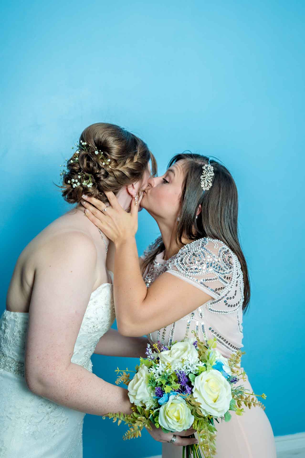 Sister kissing bride at City Hall marriage, Cardiff