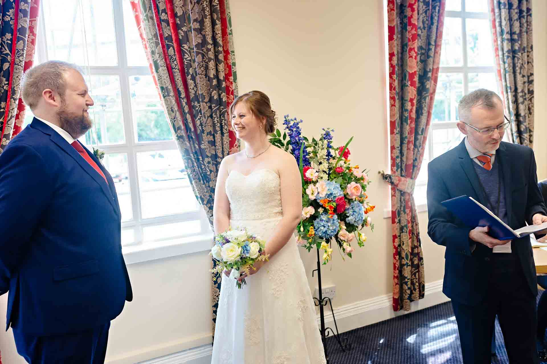 Bride smiling at groom at wedding in St. Dwynwen’s Room Wedding at Cardiff City Hall