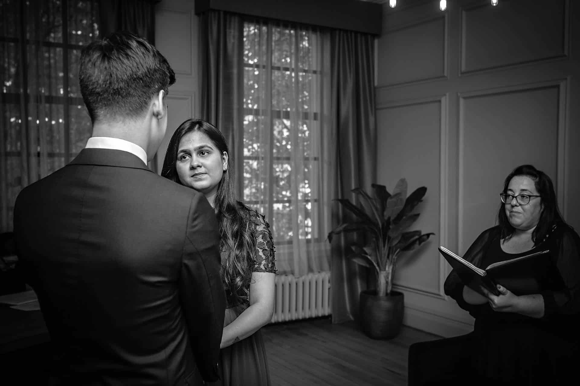 Bride looking at Groom during Wedding Ceremony in Soho Room of Old Marylebone Town Hall