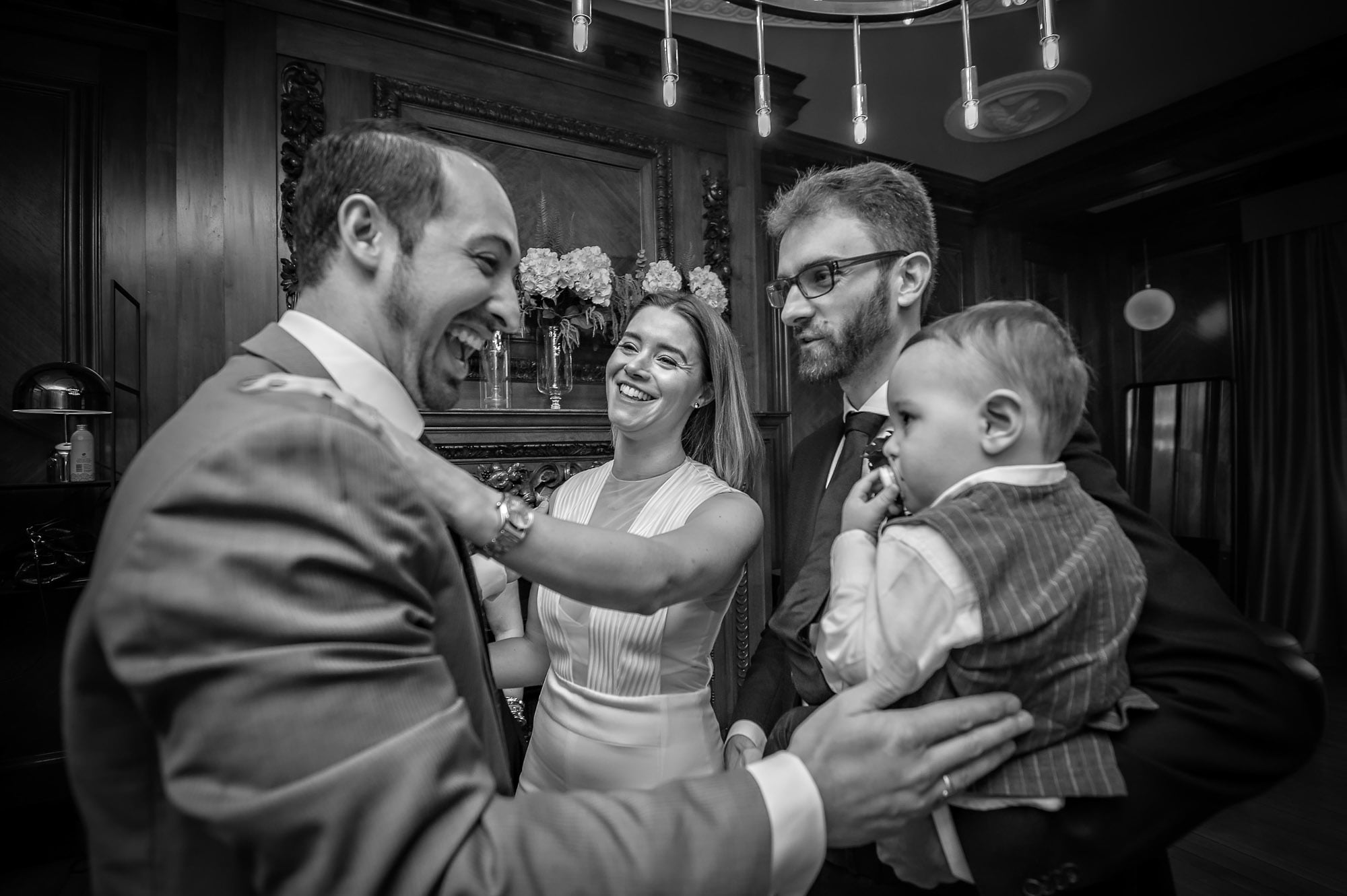 Guest congratulating bride and groom and their little boy at last-minute wedding in Westminster, London