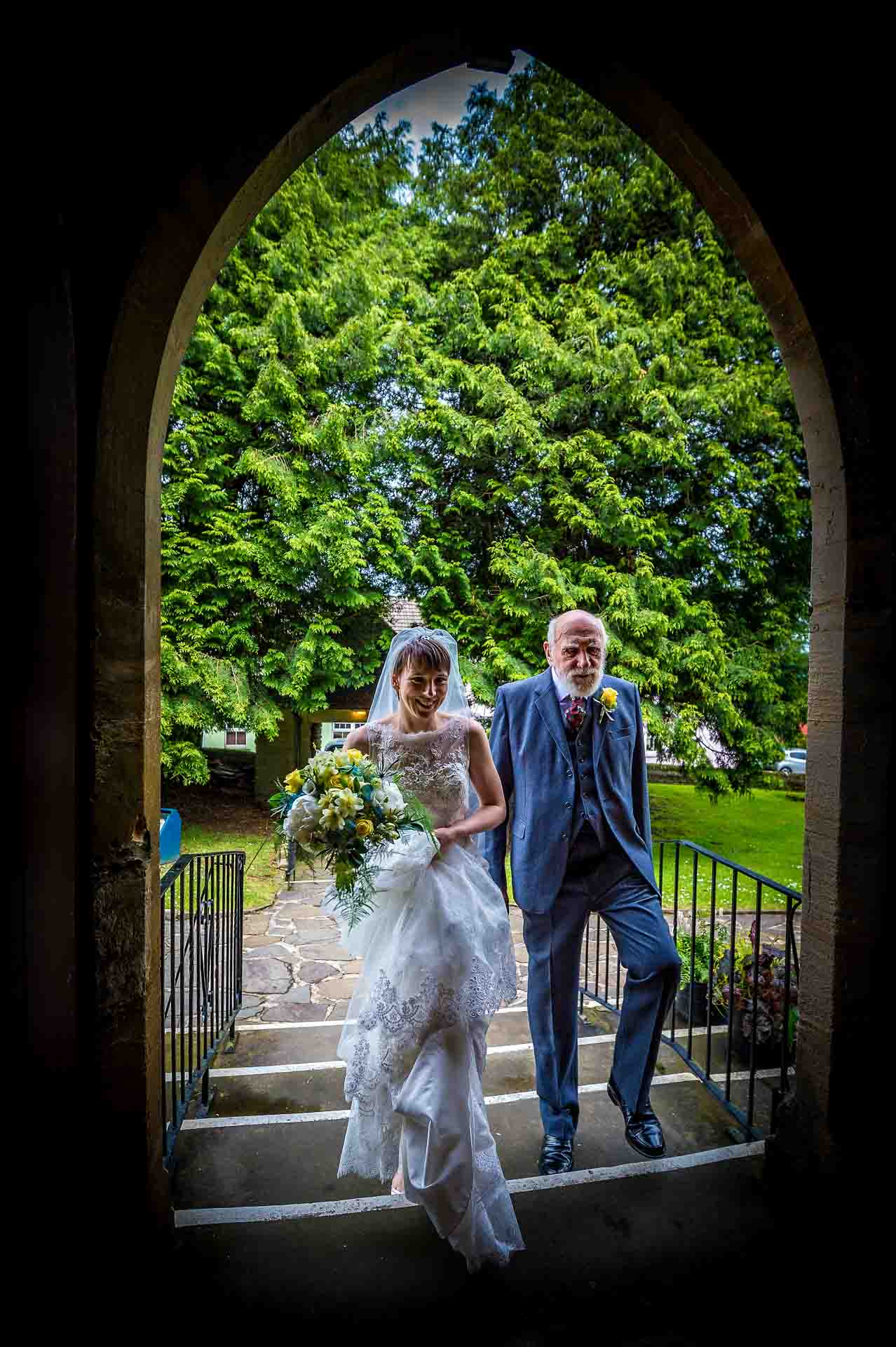 Bride and grandfather entering St Martins Church in Caerphilly for wedding