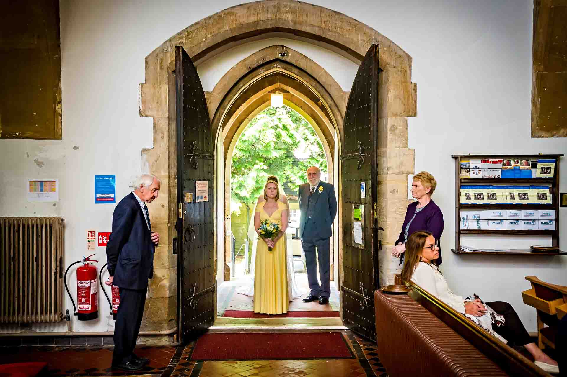 Bridal party waiting at door of St Martins Church, Caerphilly