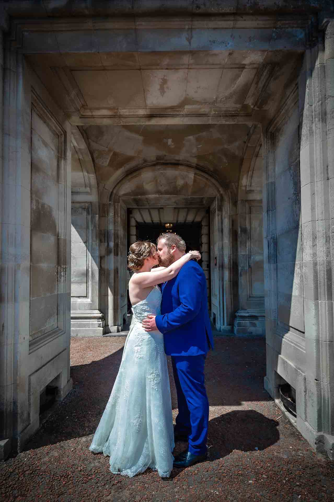 Wedding Portrait of Couple Kissing Outside Cardiff City Hall