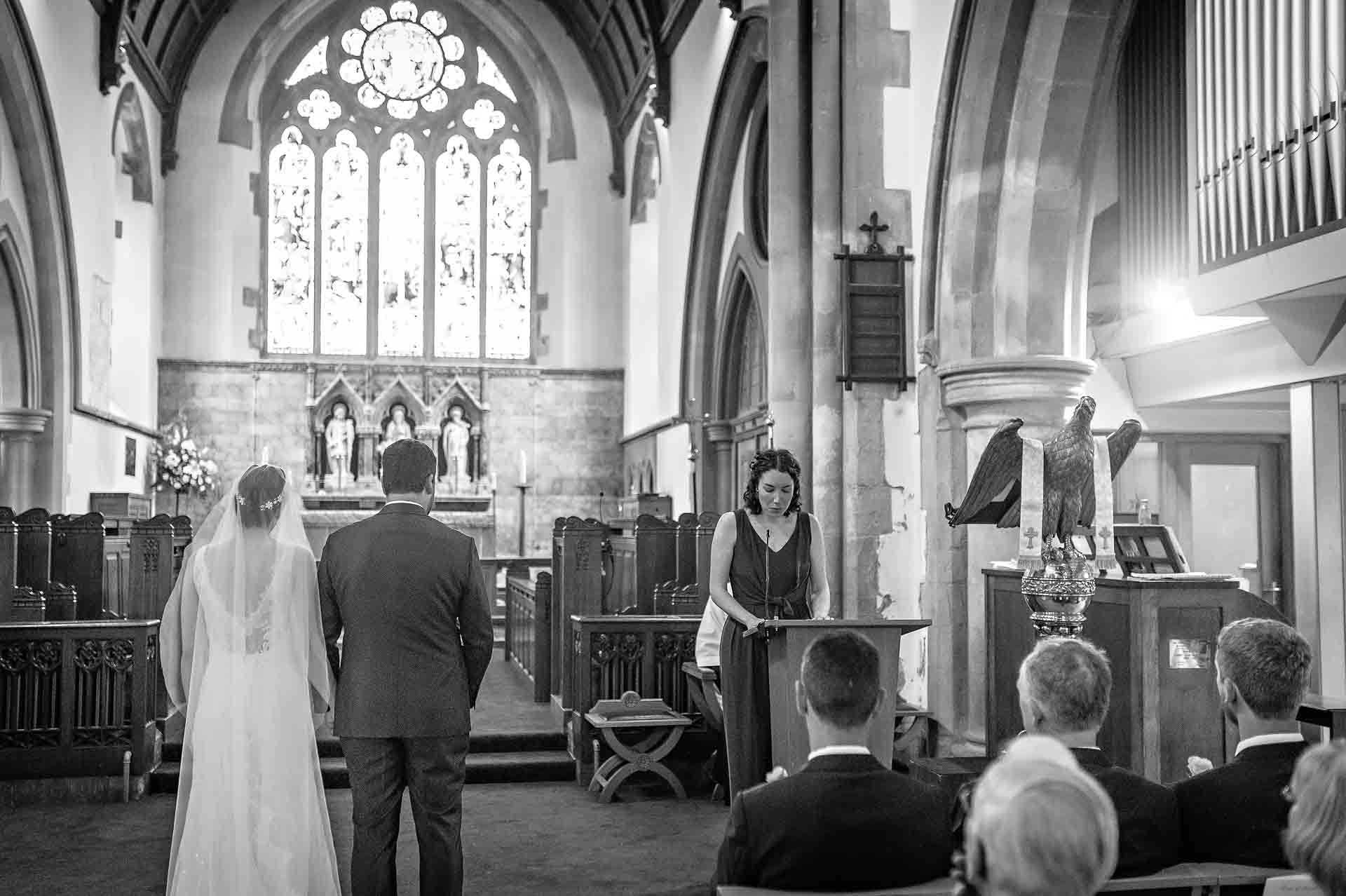 Female friend of wedding couple reads from the pulpit at St Martin's Church in Caerphilly