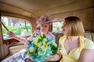 Mother and sister of the bride in back of Rolls Royce on way to ceremony